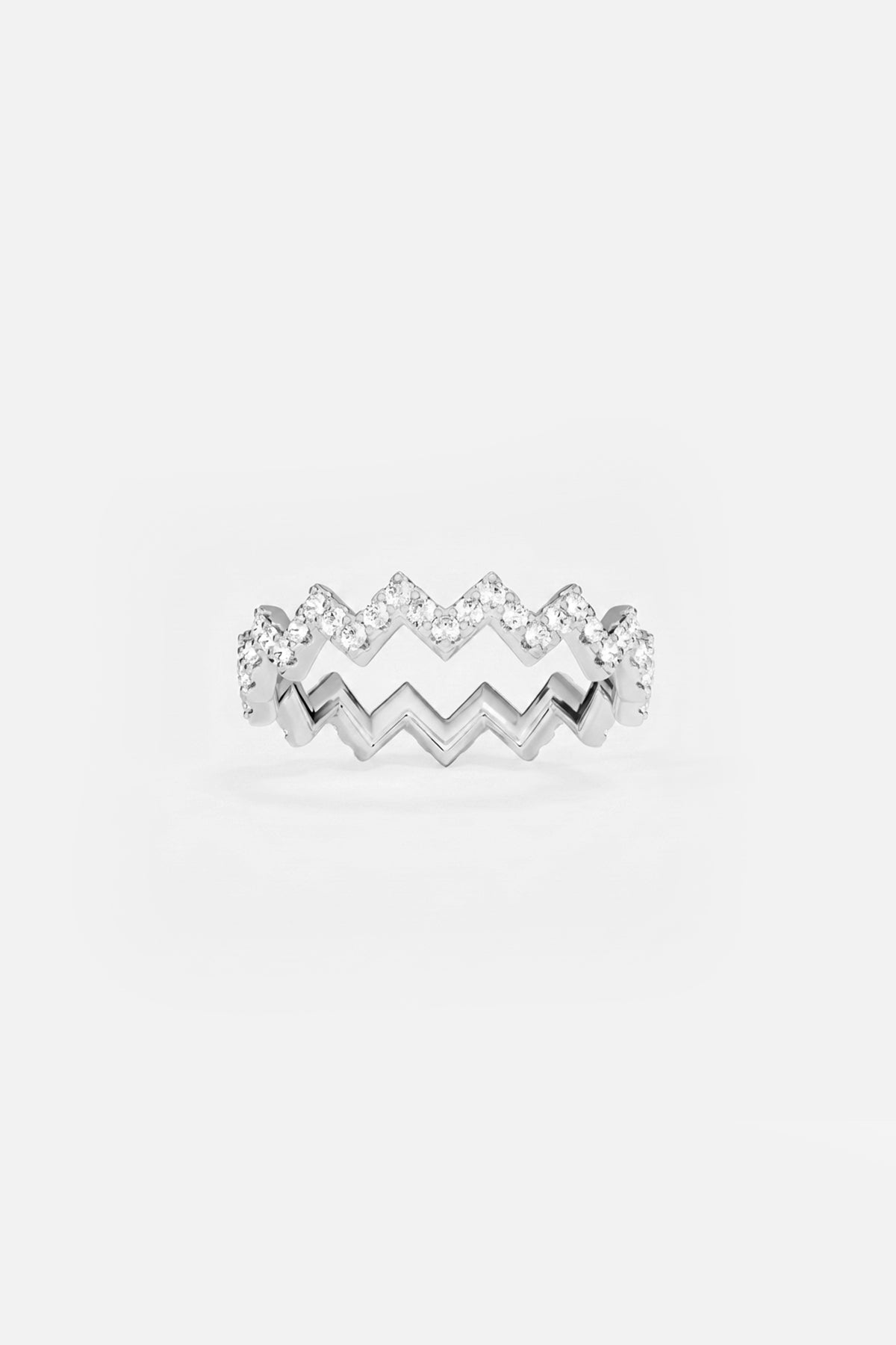 APM Ring, zigzag rhythm in rhodium finish, sparkling with effortless modern grace.