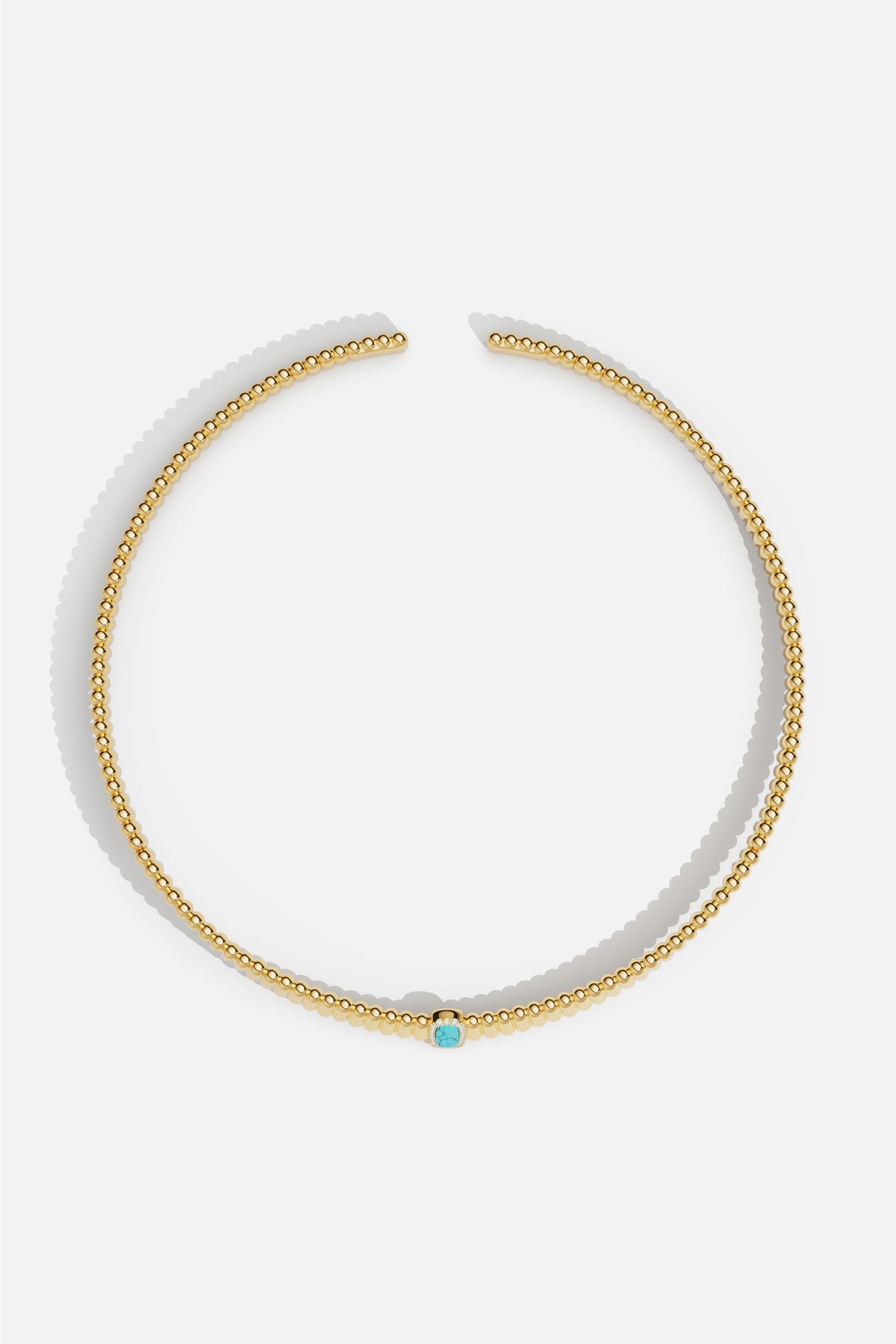 APM beaded necklace in golden hue, a turquoise touch whispering quiet elegance.