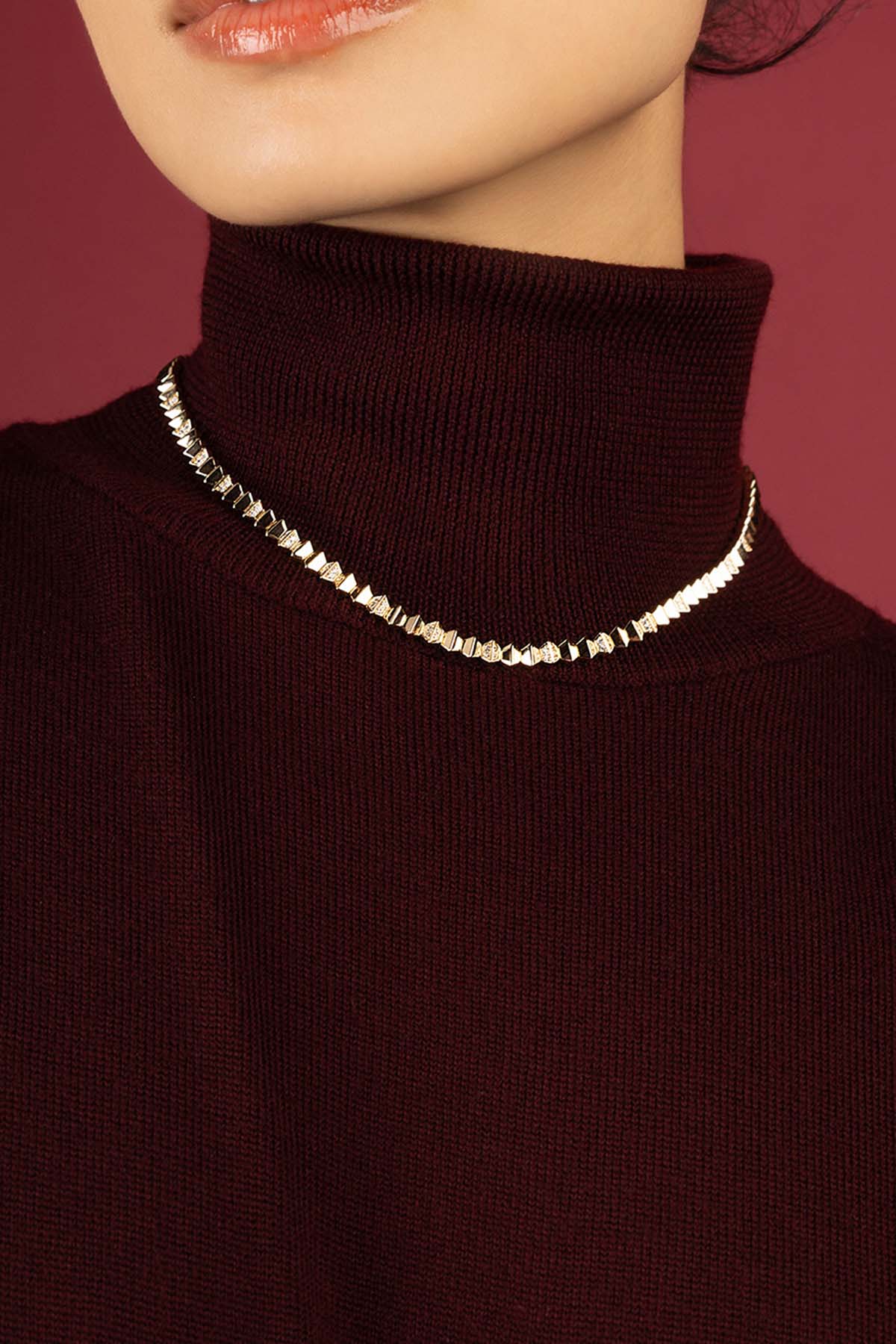 Woman wearing APM Monaco necklace, a luminous line of quiet confidence.