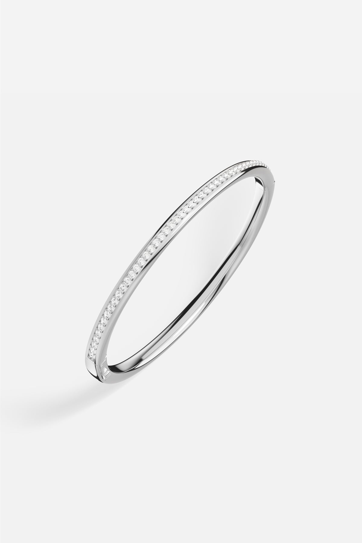 APM Bangle in rhodium finish, a sleek line of quiet radiance.