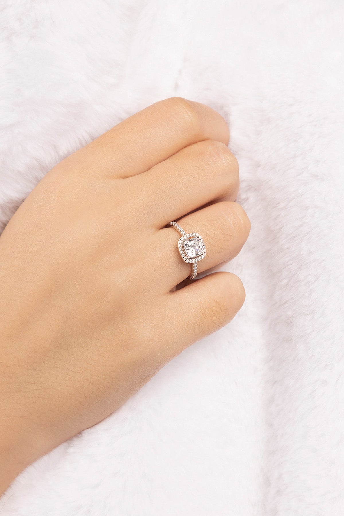 APM MONACO silver ring with a small square design on a hand against a white background