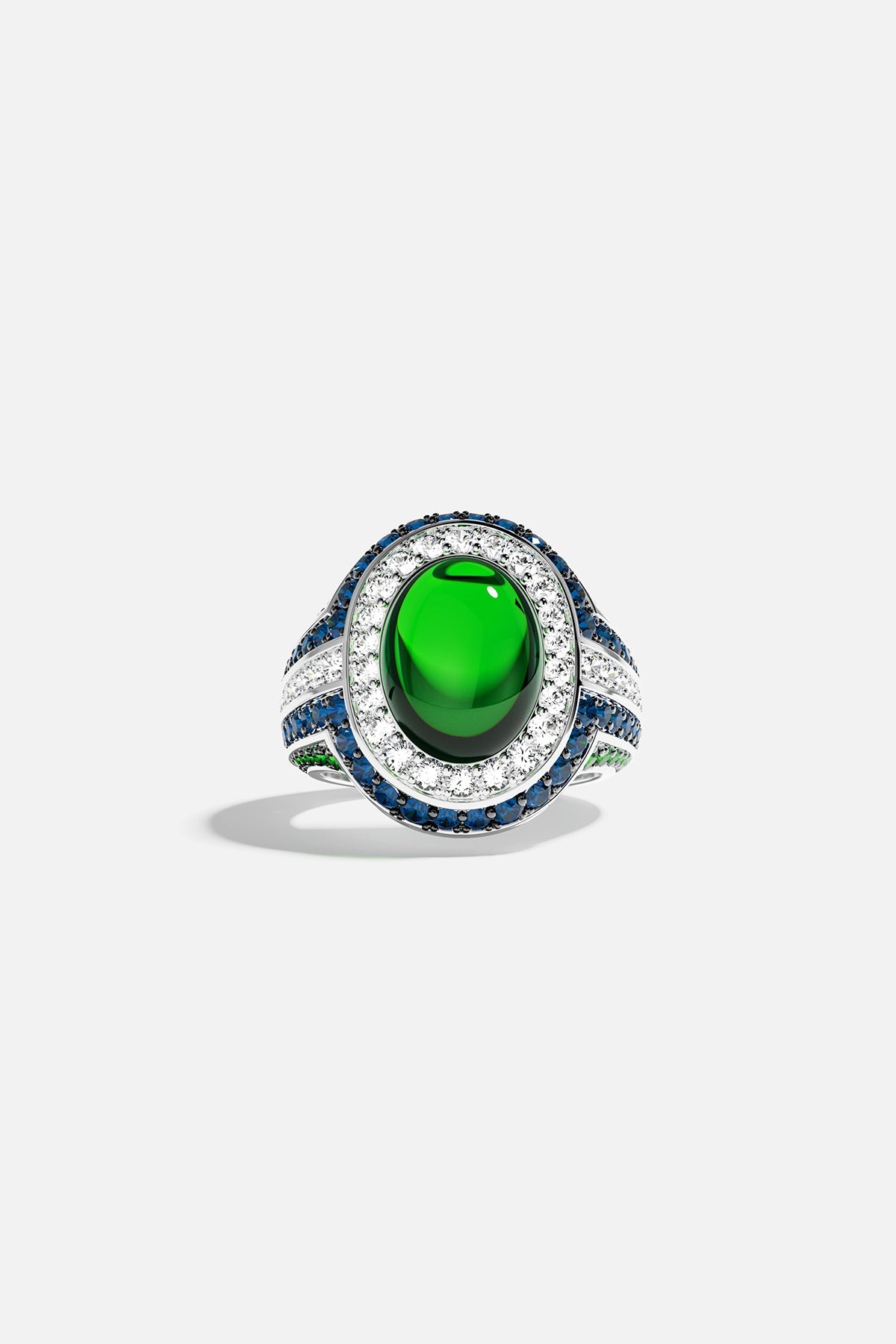 Ring with a green stones and blue accents on a white background