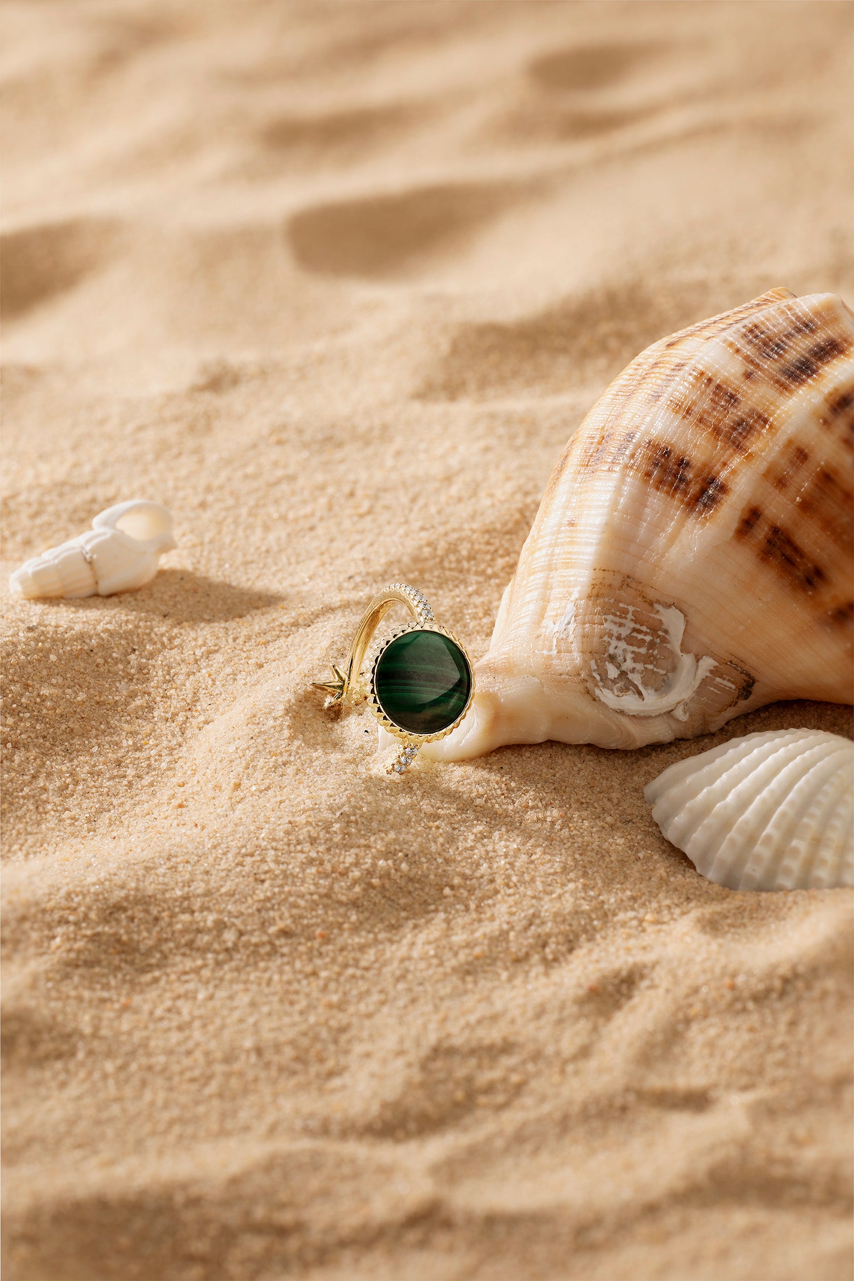 APM Monaco Malachite Météorites Ring in Yellow Gold on soft beach