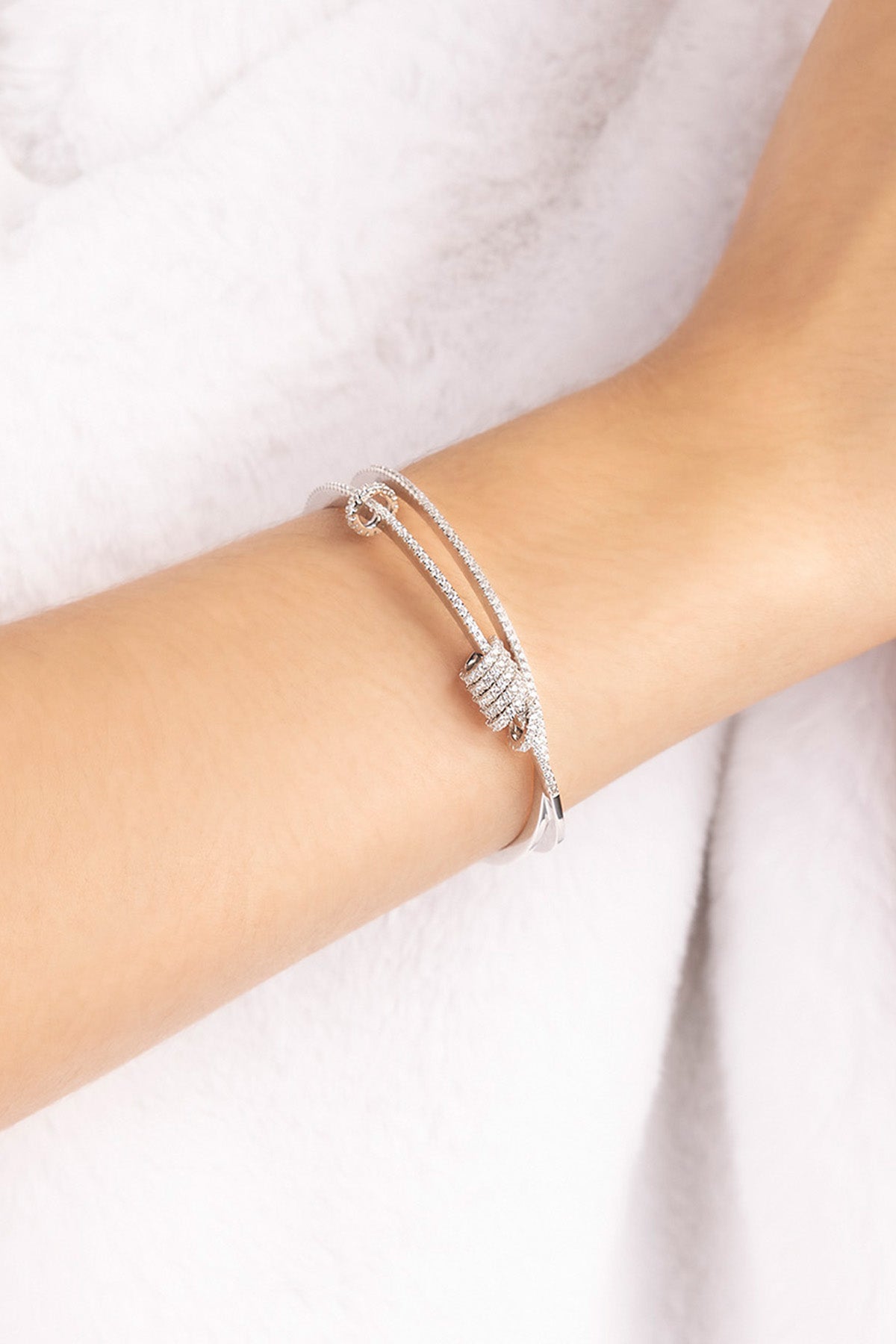 Silver APM MONACO double-open cuff with sliding design on a model's wrist against a white background