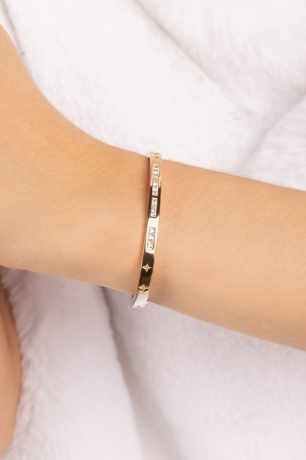 Gold bracelet on a white background