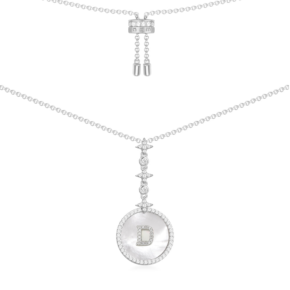 Necklaces APM Monaco — Silver chain with a round pavé pendant featuring a central letter D; adjustable length at the far end of the chain.