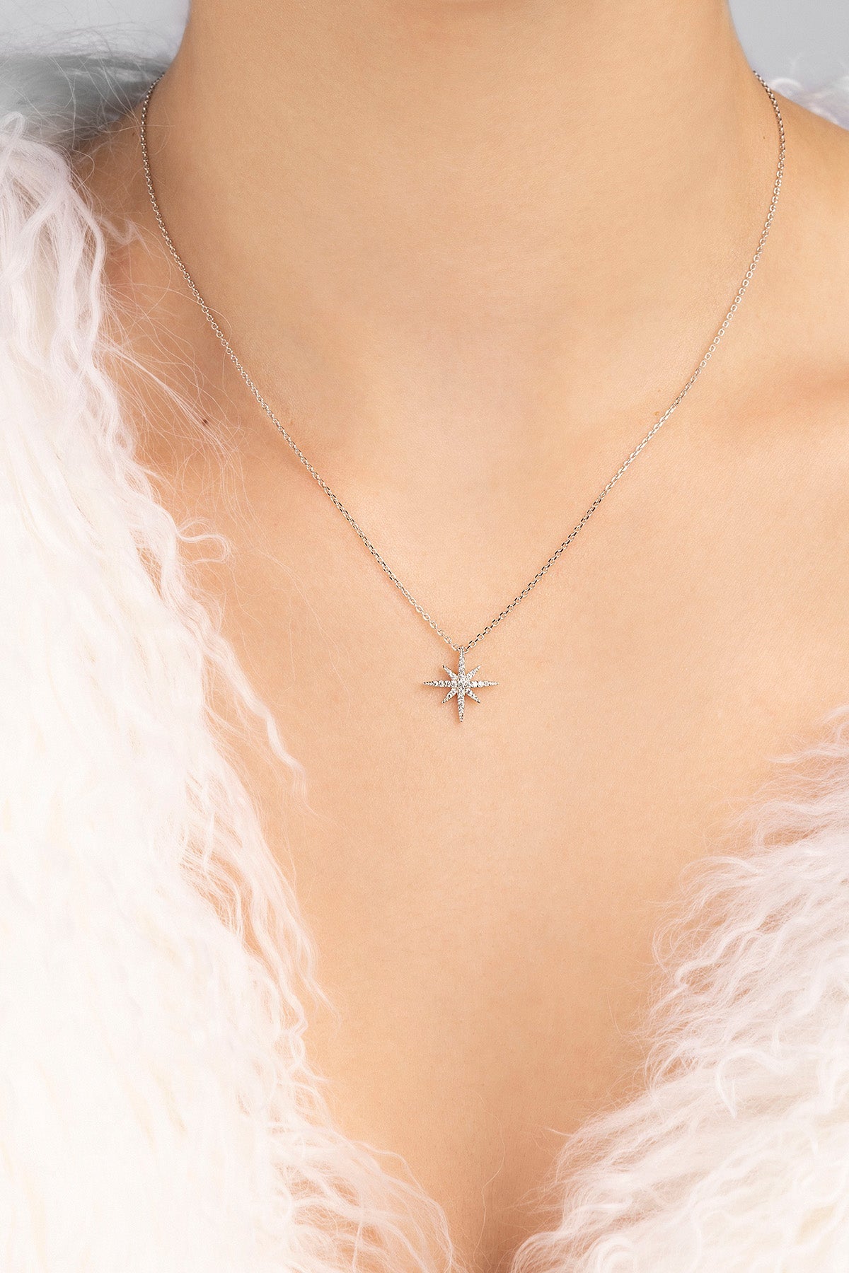 Star-shaped necklace on a model with a light background