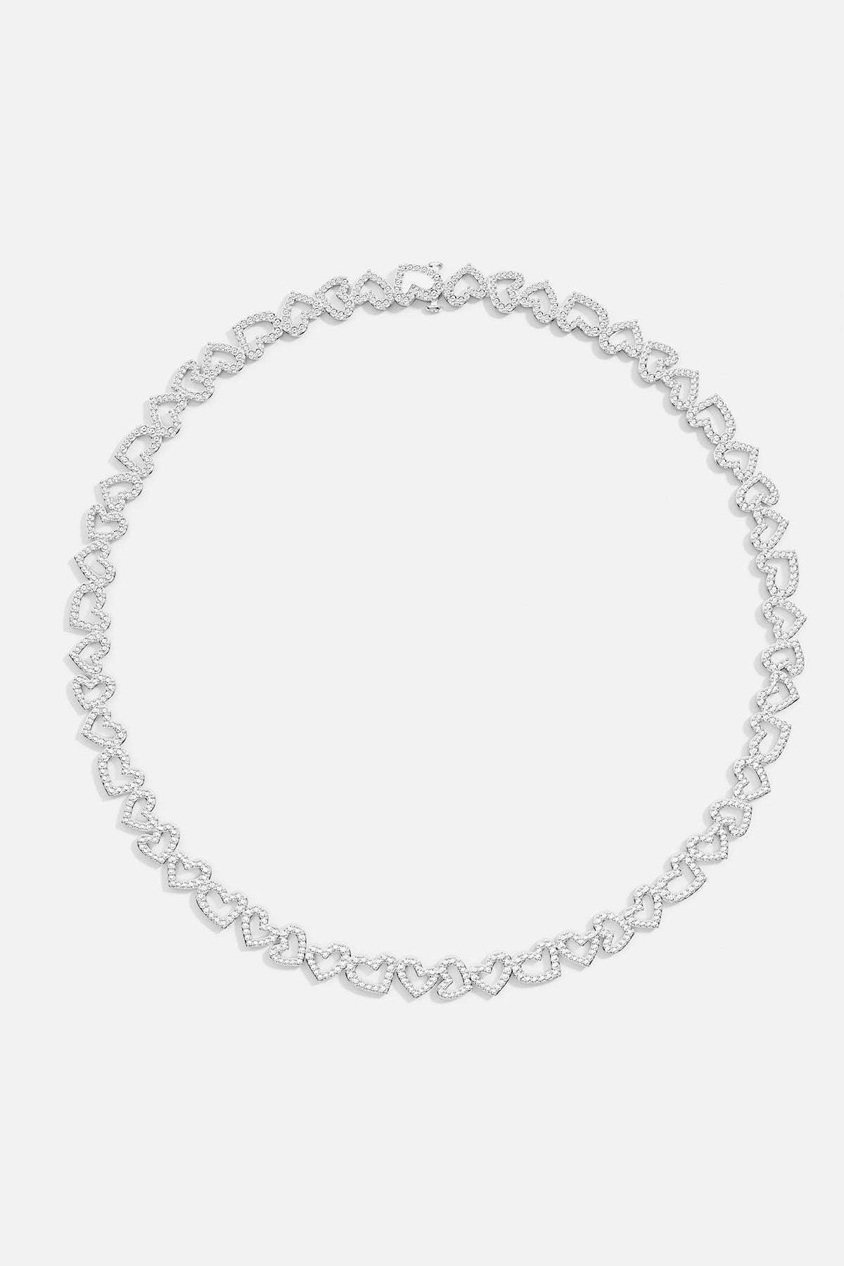 APM MONACO silver heart-shaped necklace on a light gray background