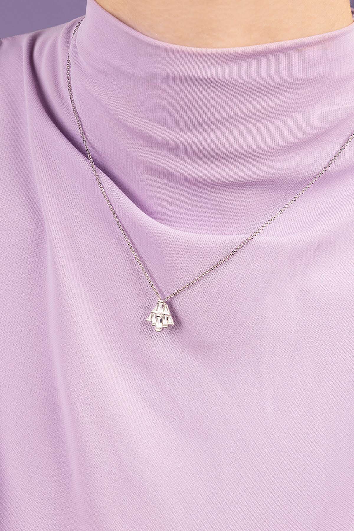 Model wearing art deco necklace paved with white zirconia