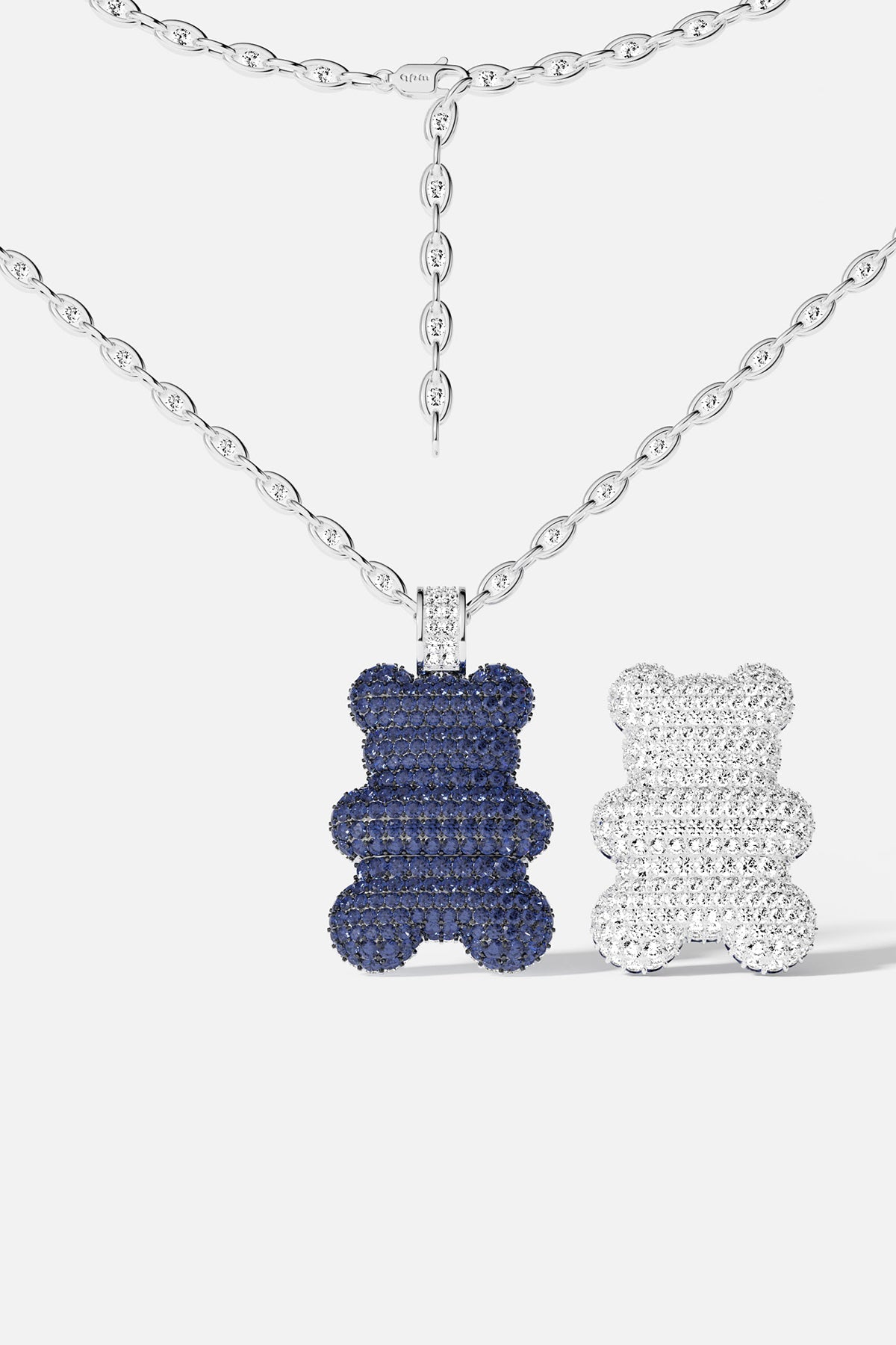 bear-shaped pendants, each side with different color, blue and silver, on a white background.