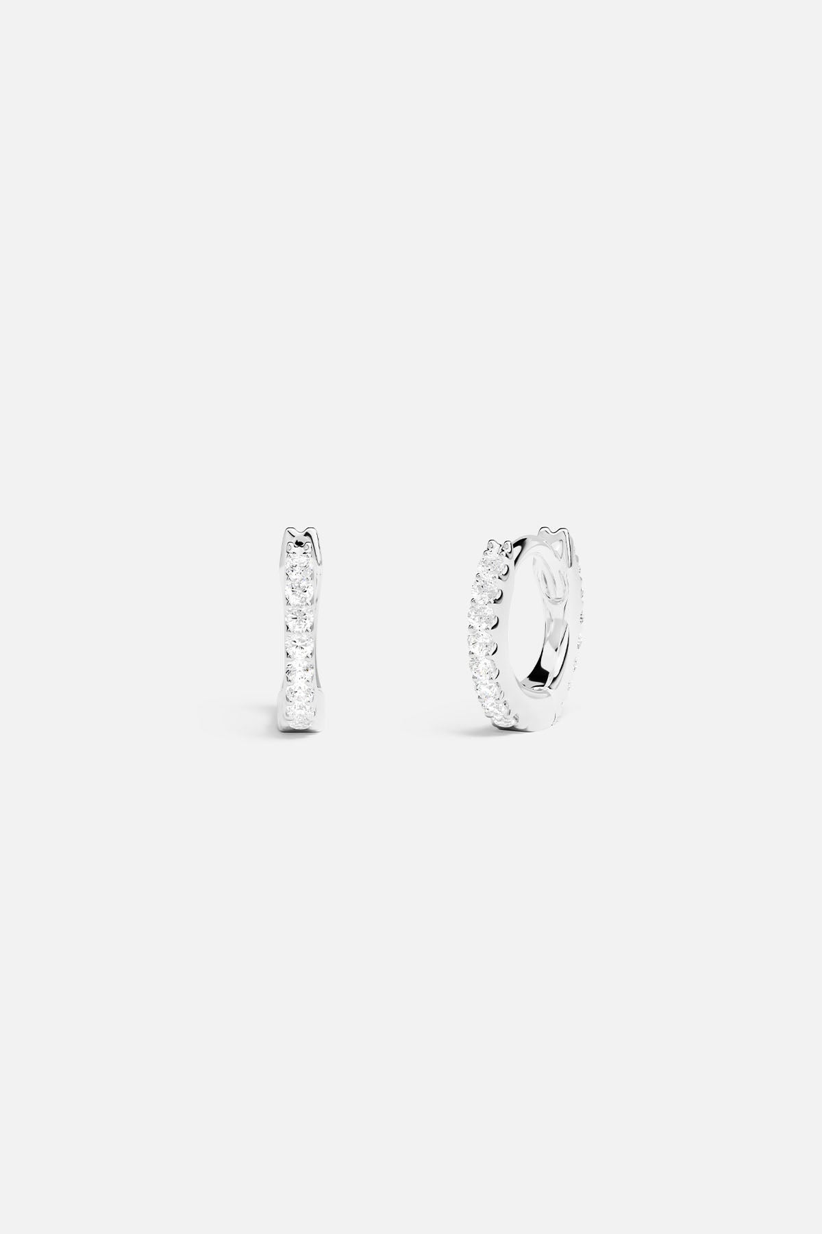 Earrings APM Monaco silver-tone small 6-mm pavé hoop earrings with white stones.