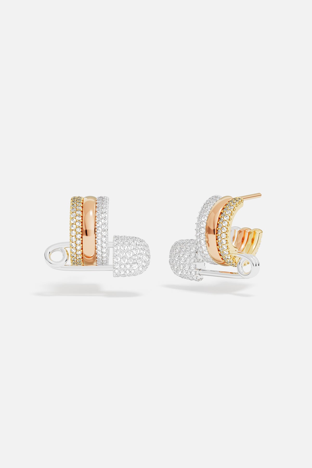 Pair of rose gold & sterling silver hoop safety pin earrings with pavé accents on a white background