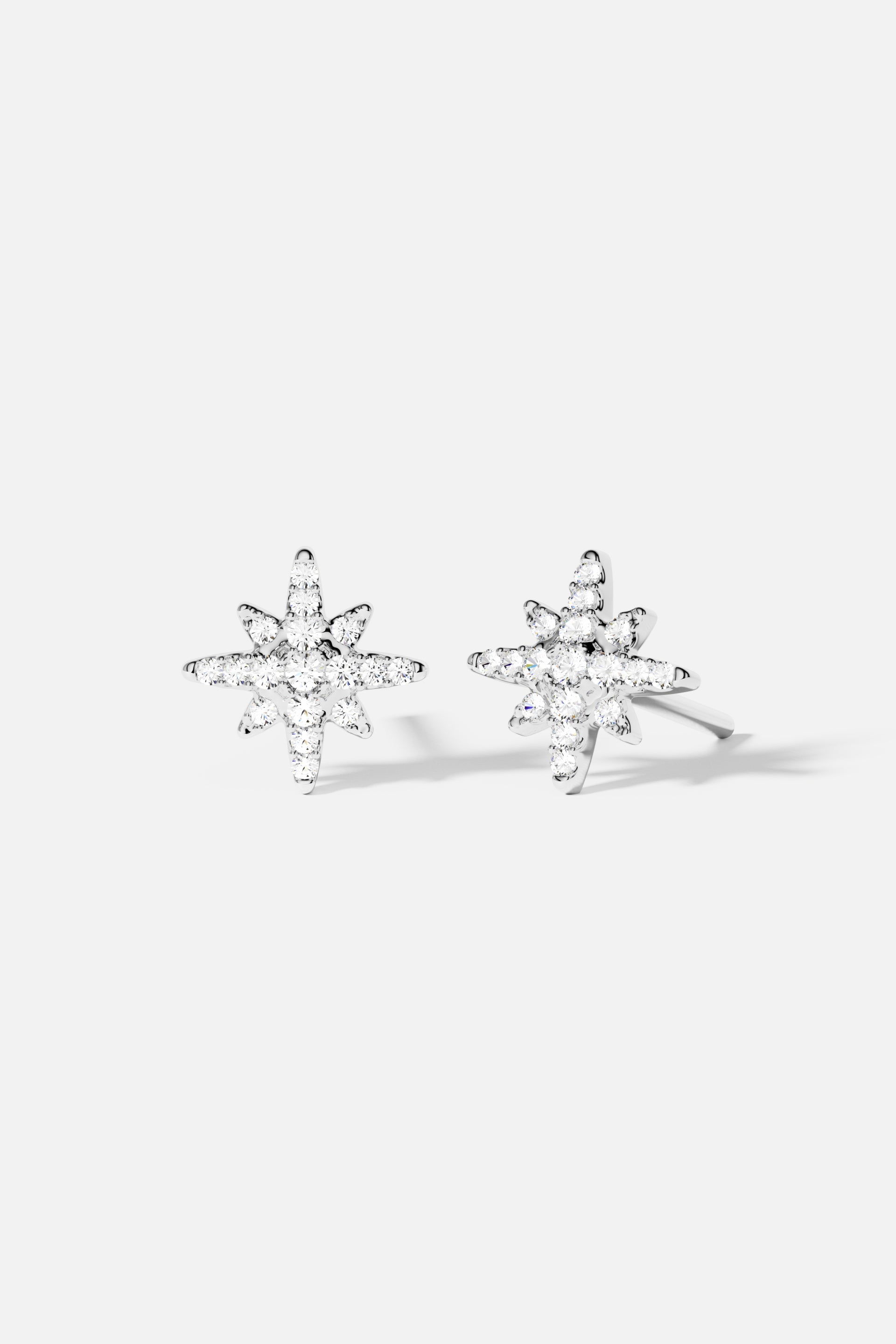 Earrings APM Monaco. silver star-shaped stud earrings with meteorite texture.