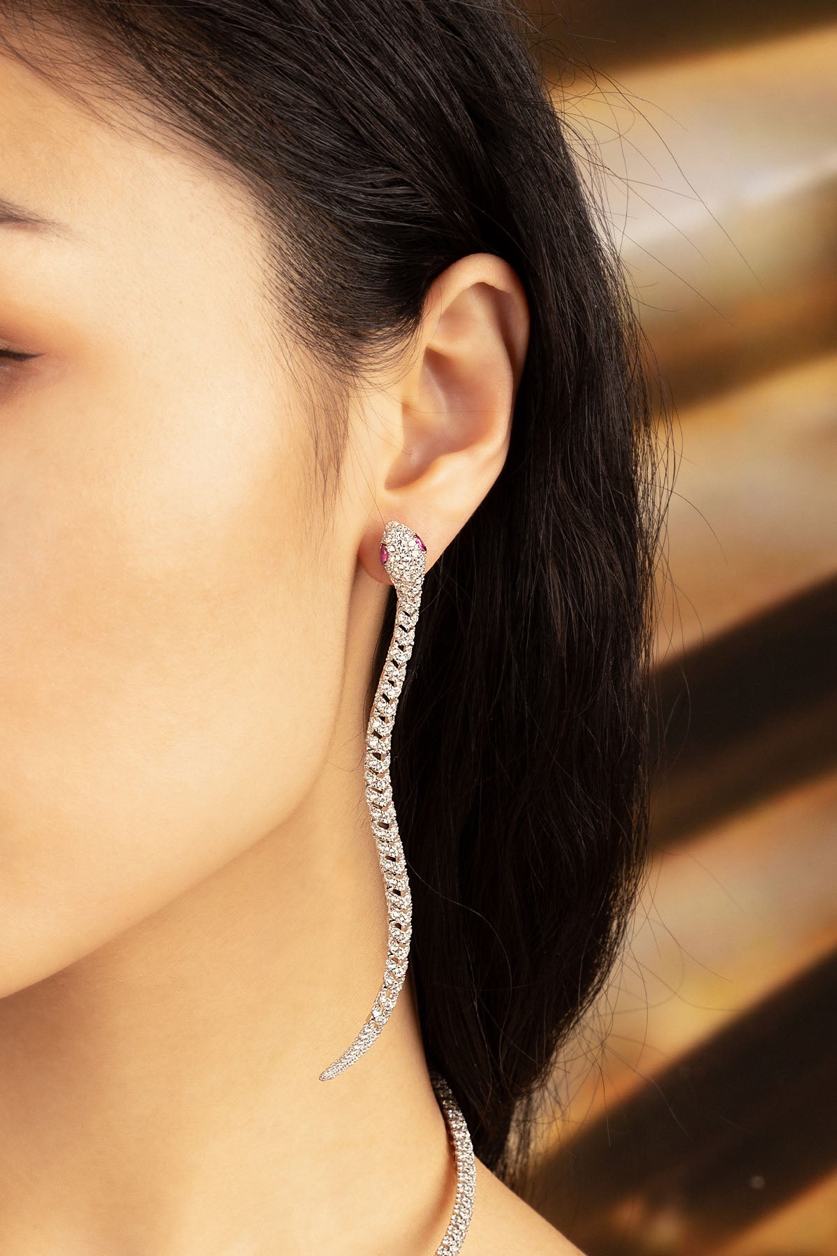 APM Monaco Pavé Kaa Drop Earrings in Silver worn on ear