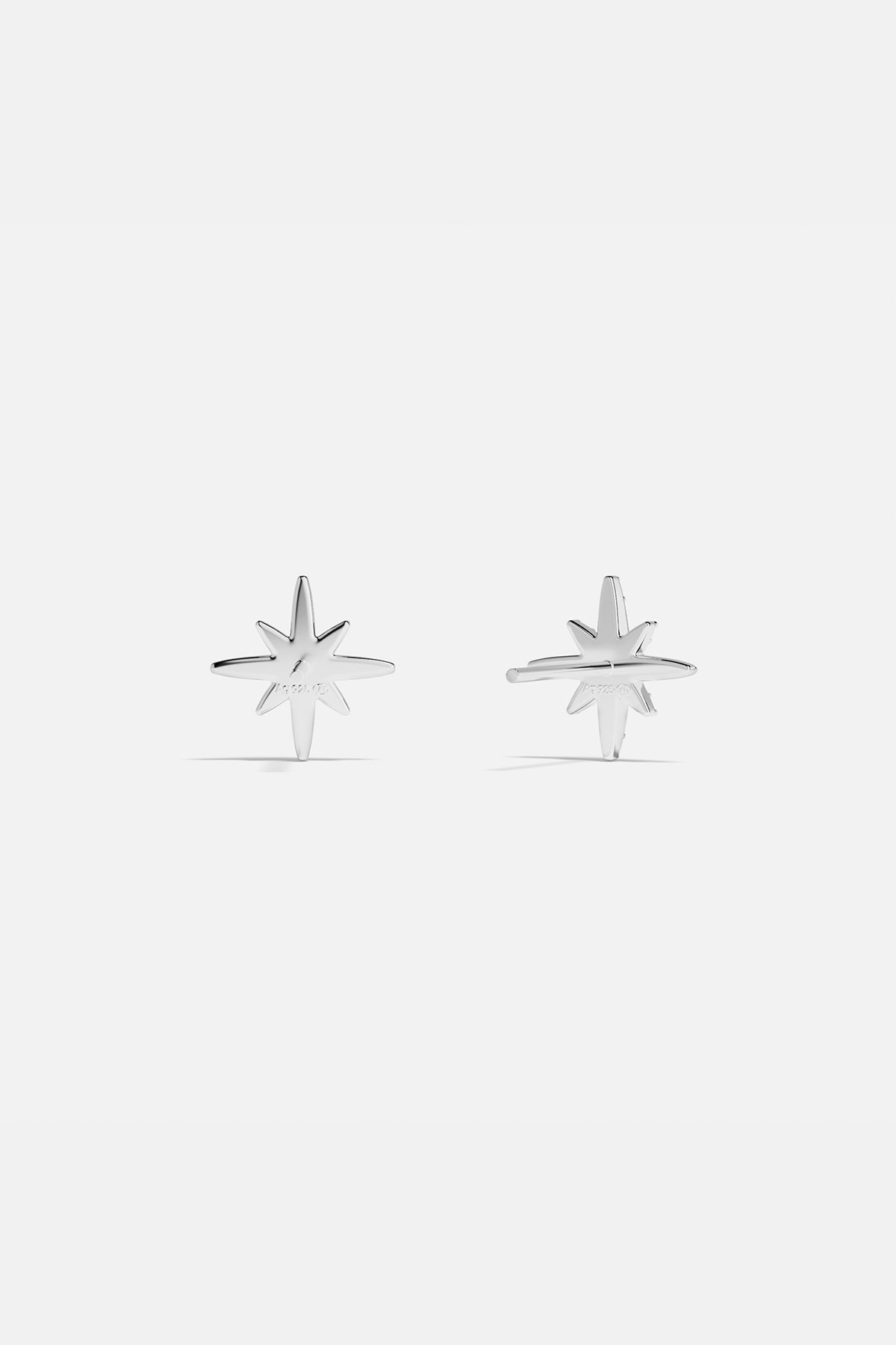 Earrings APM Monaco: silver starburst stud earrings with white stones.