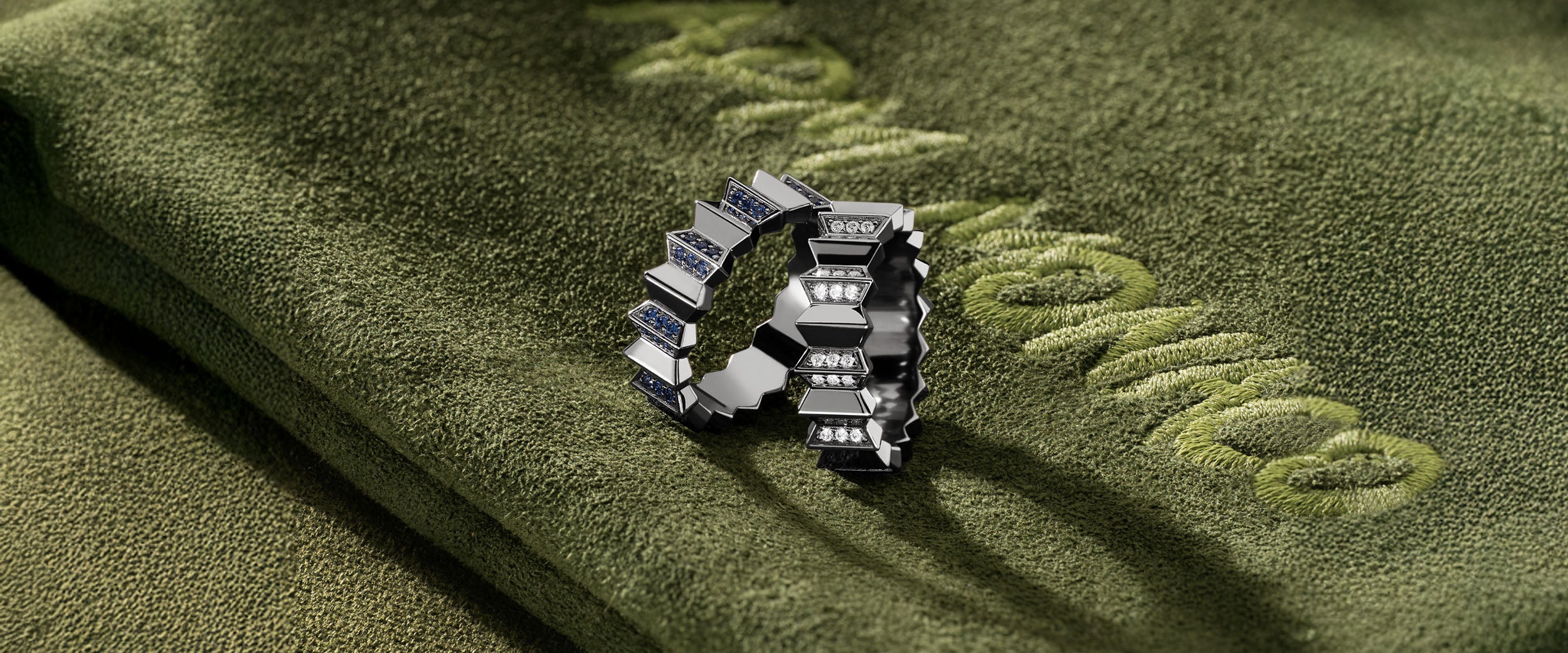 APM MONACO silver ring from morse code collection on a green fabric surface