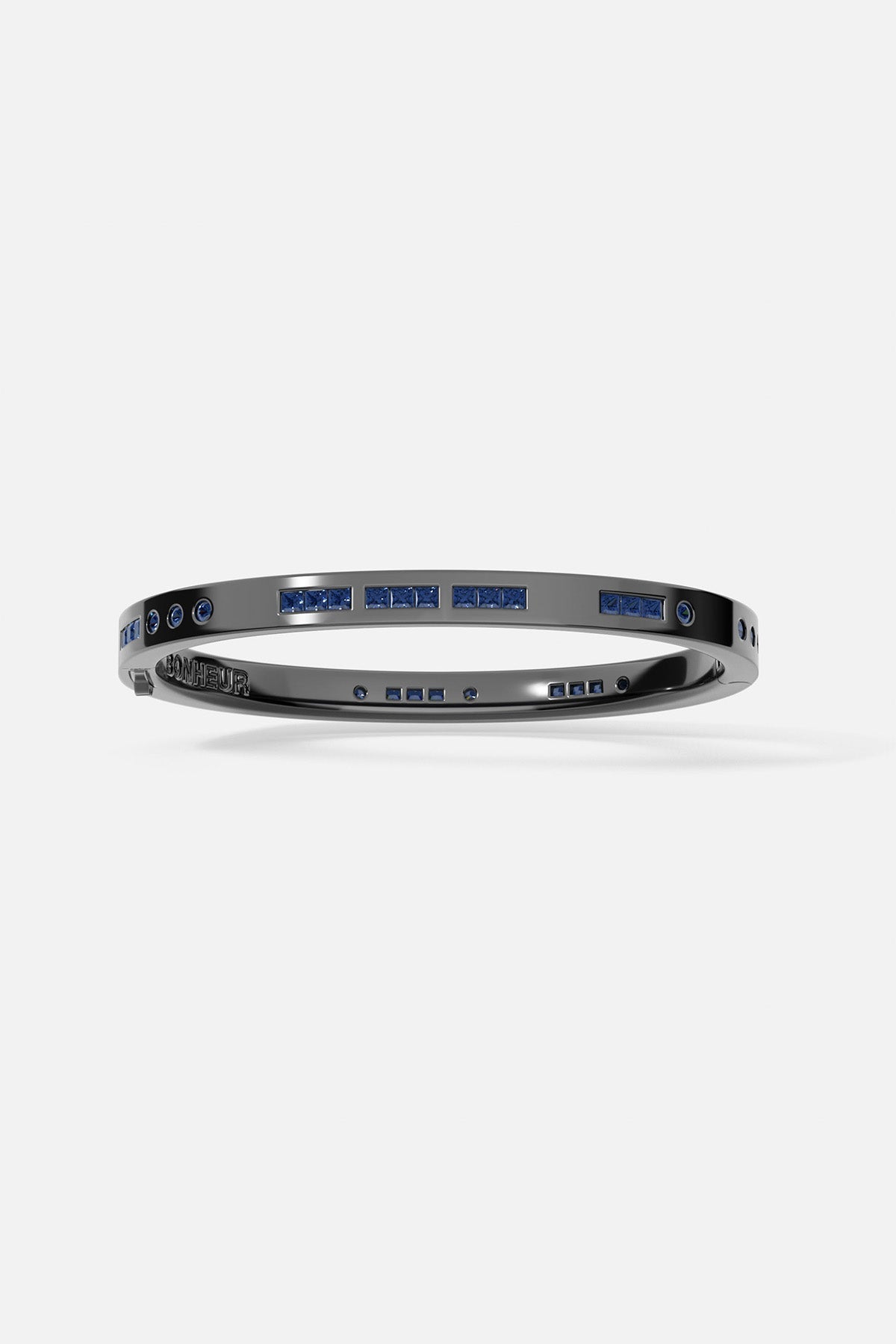Bracelets APM Monaco gray Morse-code bangle with blue stones spelling Bonheur on a metal band.