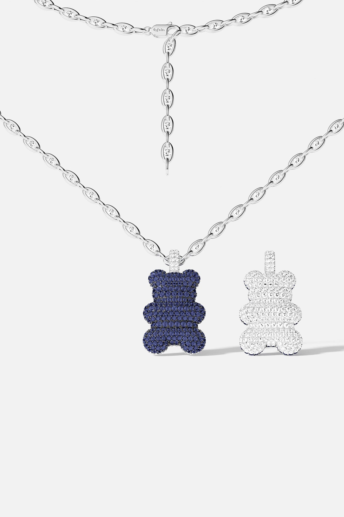Necklaces APM Monaco: adjustable silver tone chain with a blue bear pendant encrusted with white stones, paired with a matching pendant featuring clear stones.