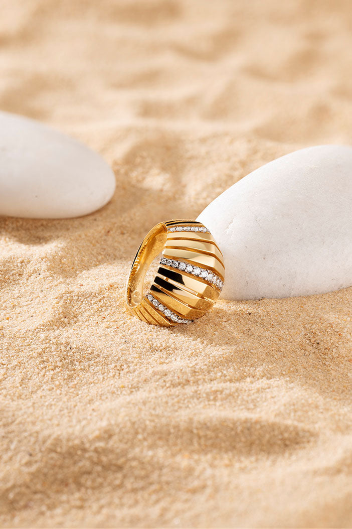 APM Monaco Rayon de Soleil Ring in Yellow Gold on soft beach