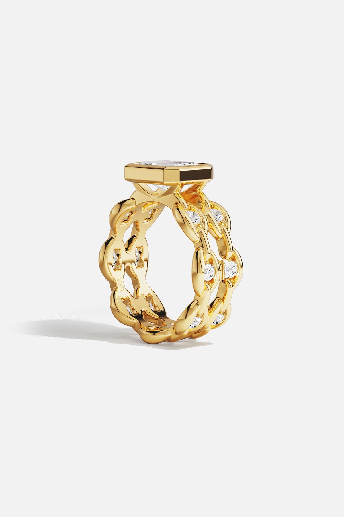 Rings APM Monaco yellow gold statement ring with a large square-cut white center stone surrounded by a pavé halo of smaller stones.