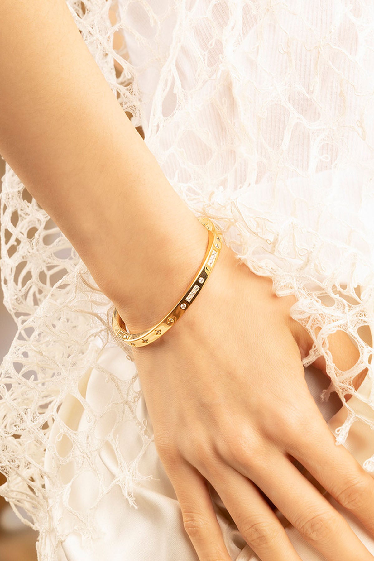 APM Monaco BONHEUR Morse Code Bangle in Yellow Gold worn on hand