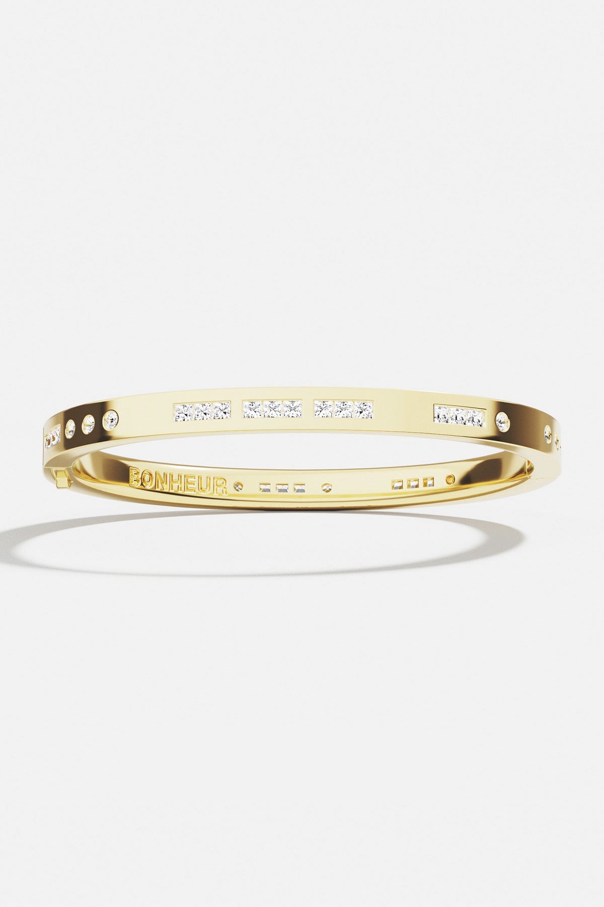 Bracelets APM Monaco yellow-gold Bonheur Morse Code bangle featuring small diamonds.