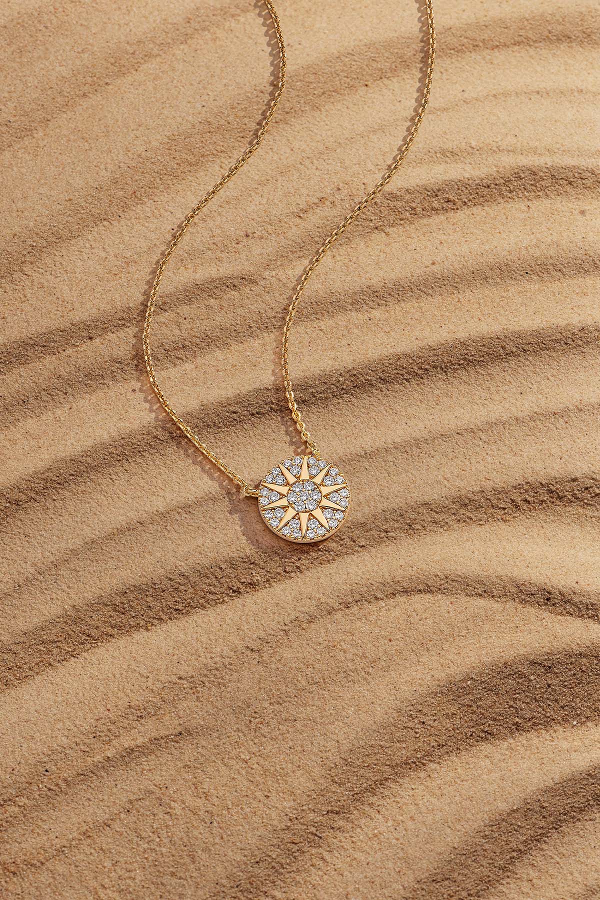 APM Monaco Soleil Necklace in Yellow Gold on soft beach