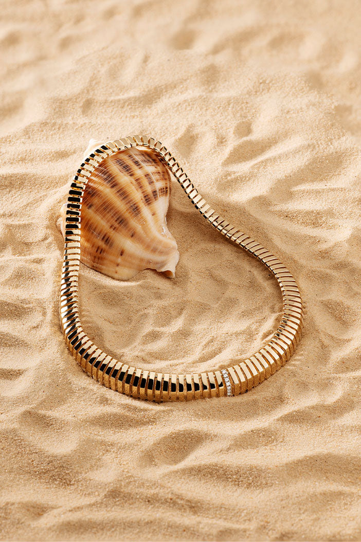 APM Monaco Rayon de Soleil Choker in Yellow Gold on soft beach