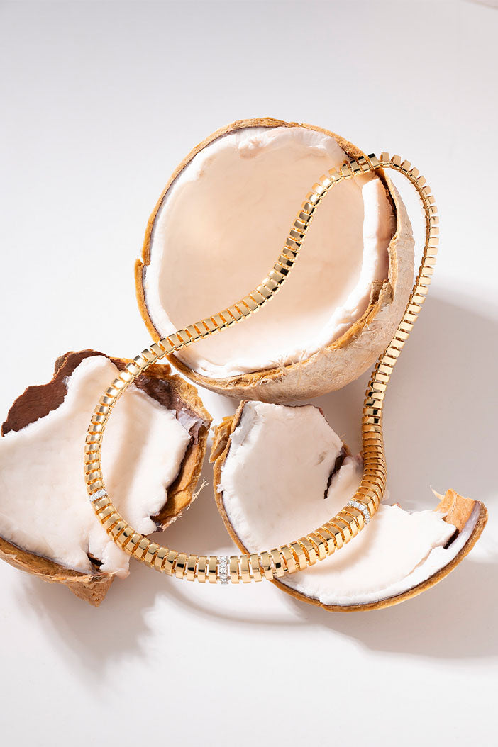 APM Monaco Rayon de Soleil Choker in Yellow Gold on coconut shell