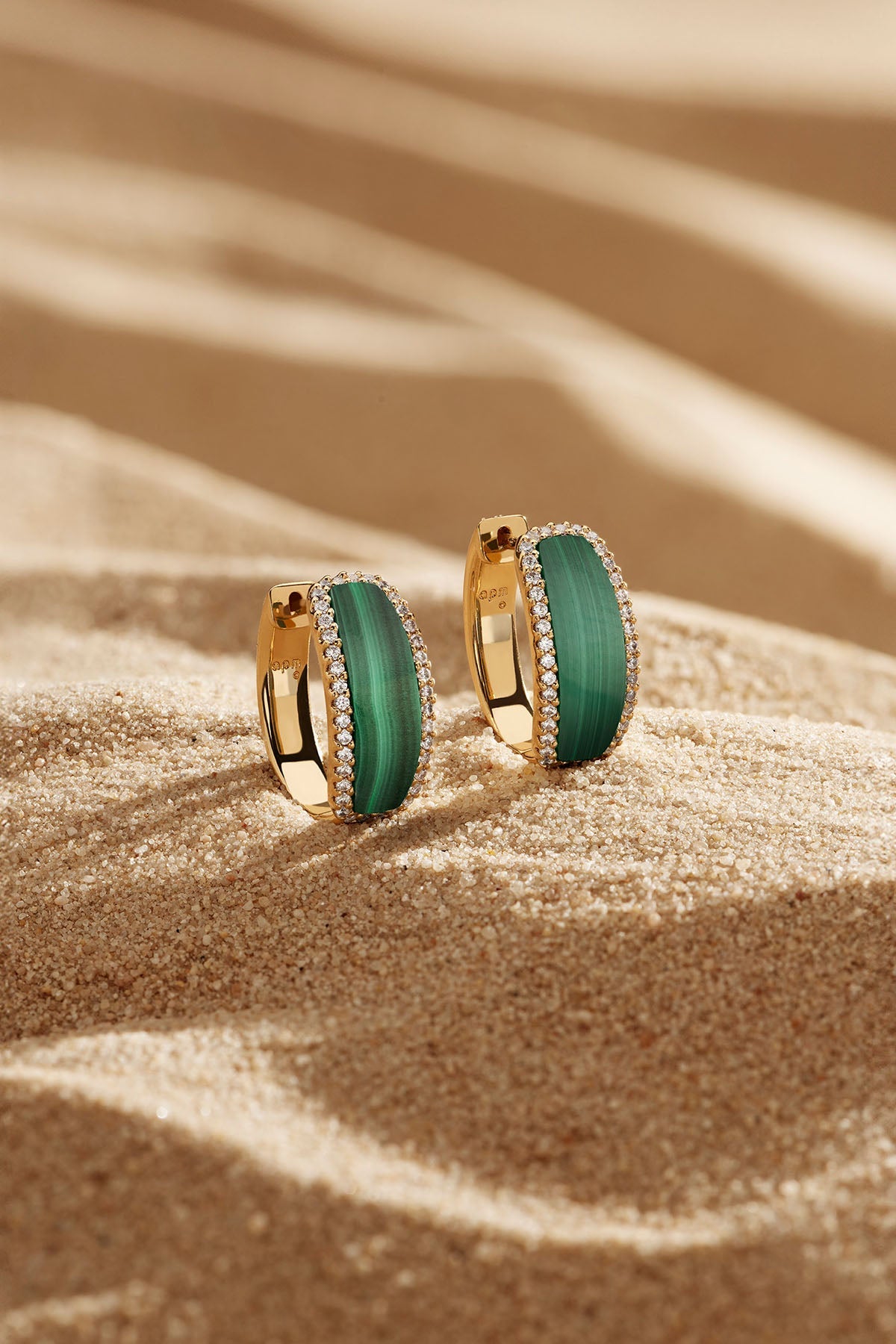 APM Monaco Malachite Hoop Earrings in Yellow Gold on soft beach