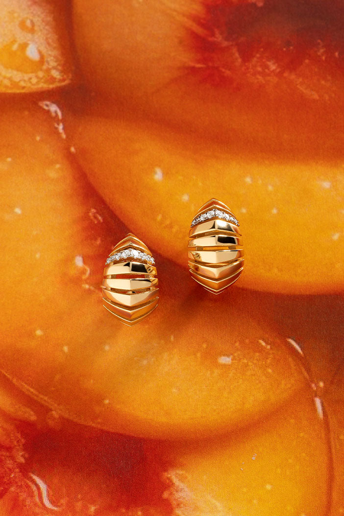 APM Monaco Rayon de Soleil Earrings in Yellow Gold on peach jam