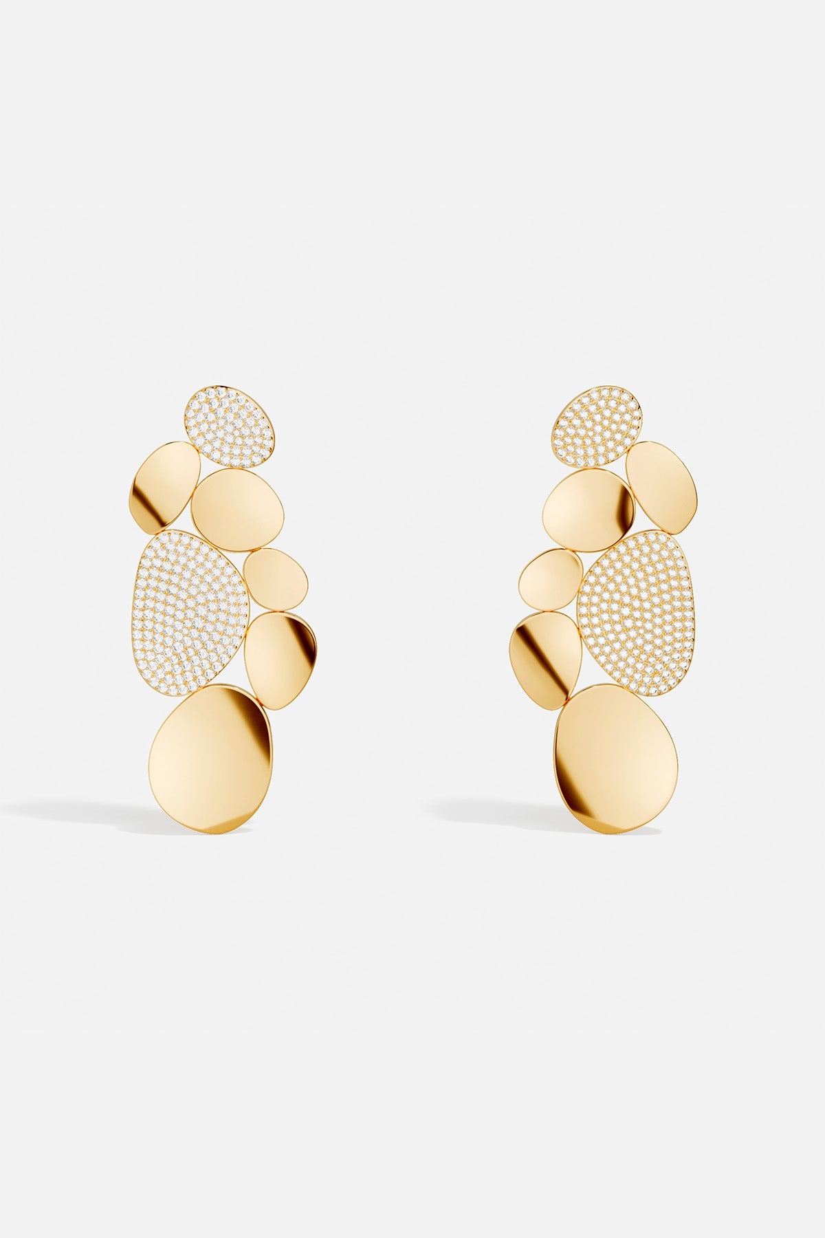 Earrings APM Monaco. Yellow gold statement earrings with overlapping disc shapes in varying sizes, some pavé-set with white stones.