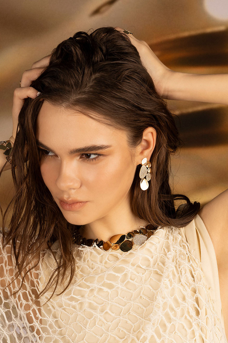APM Monaco Statement Galet Earrings in Yellow Gold worn on hand