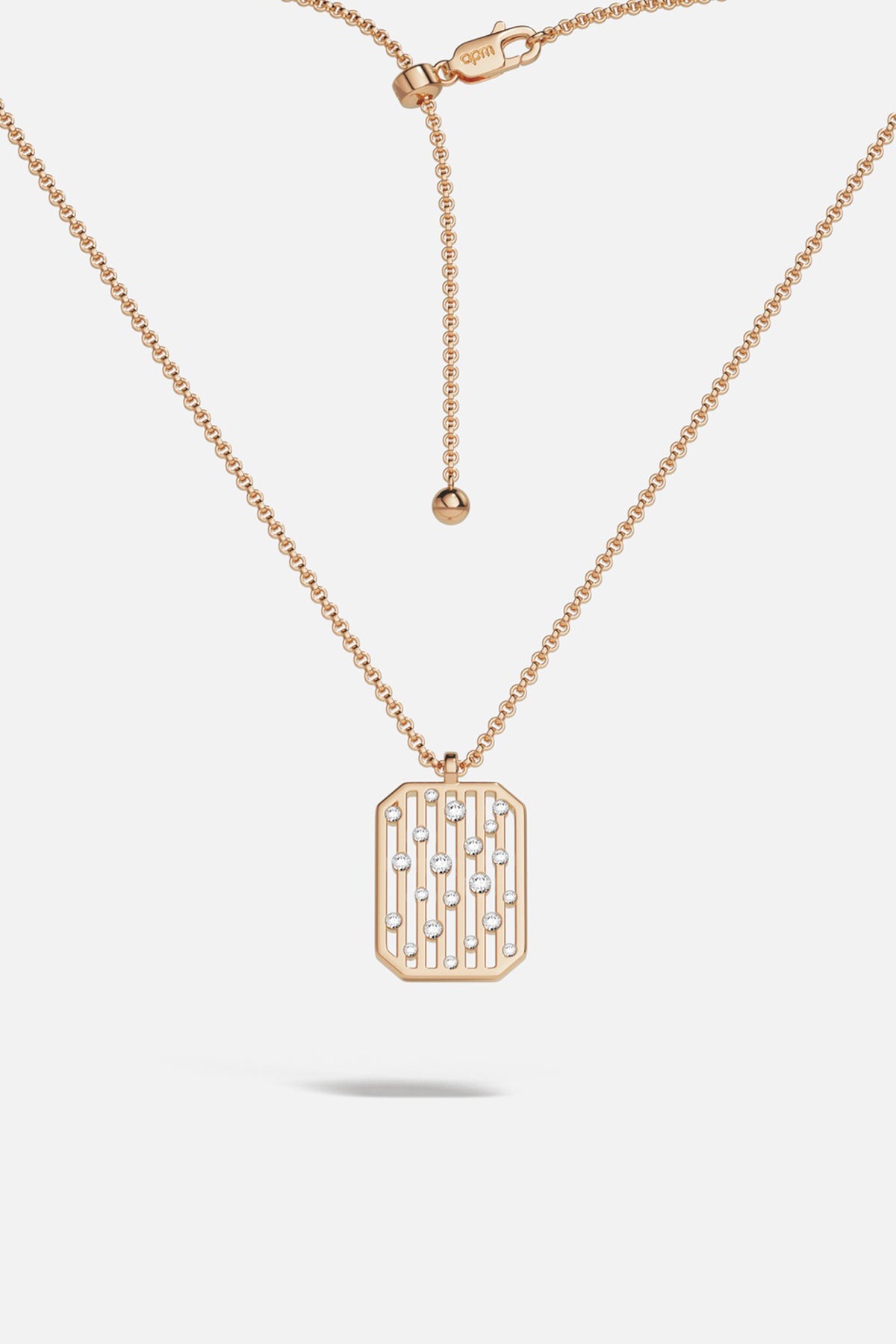 APM pendant necklace in warm rose color, radiant lines scattered with quiet sparkle.