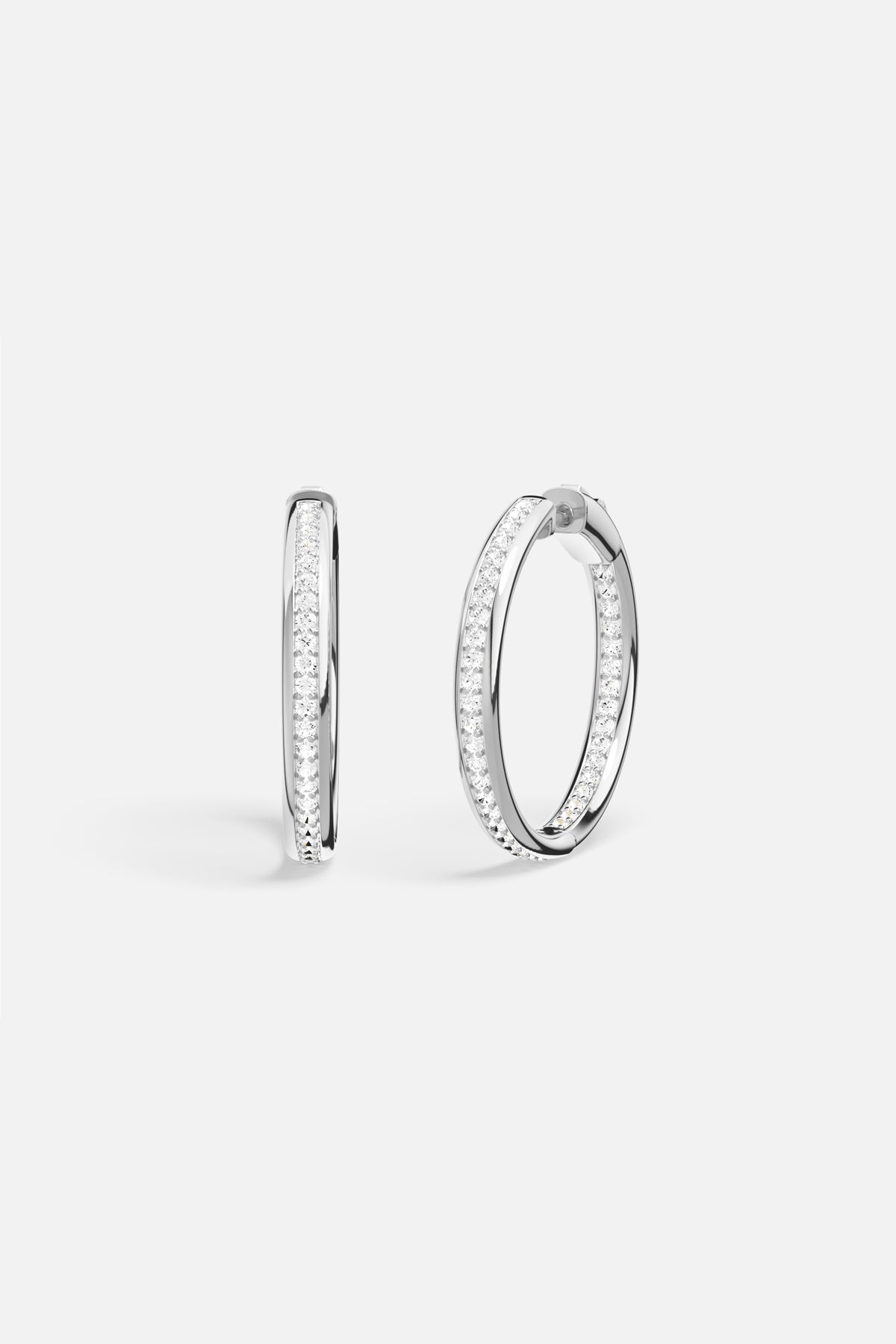 APM Hoop Earrings in rhodium finish, a luminous circle of effortless elegance.