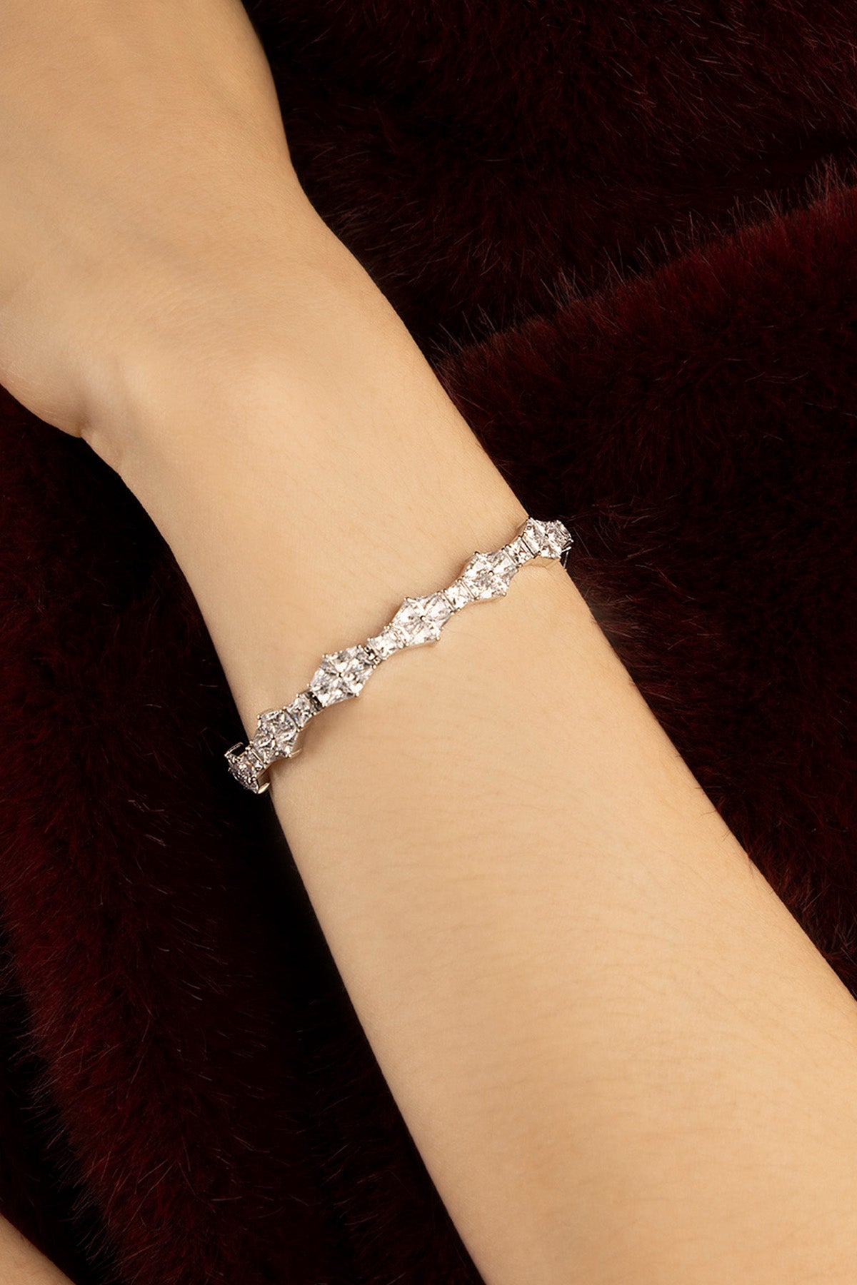 Woman wearing APM bracelet, a shimmering line of quiet elegance.