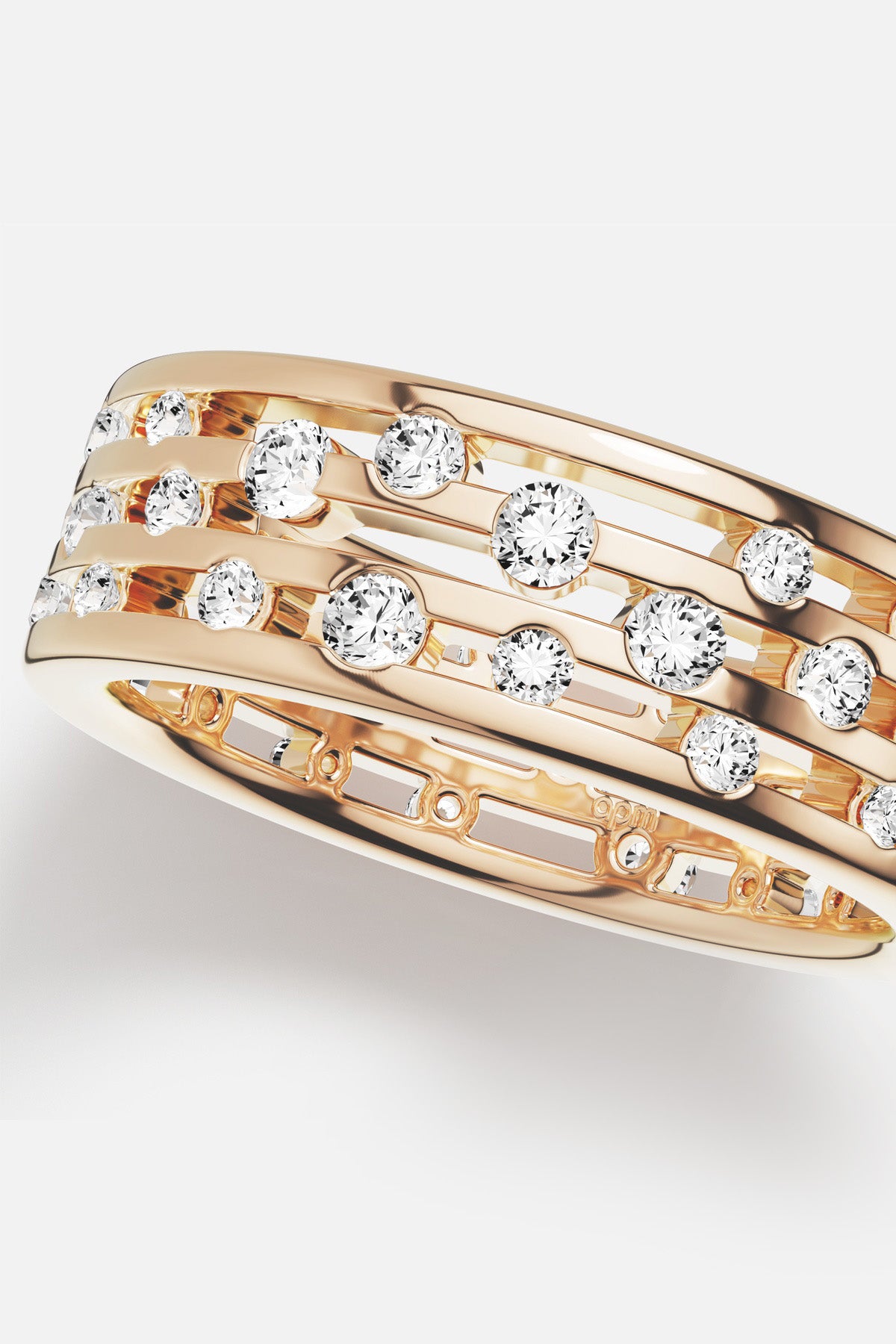 APM Ring in warm gold color, a scattering of stones shimmering with quiet radiance.