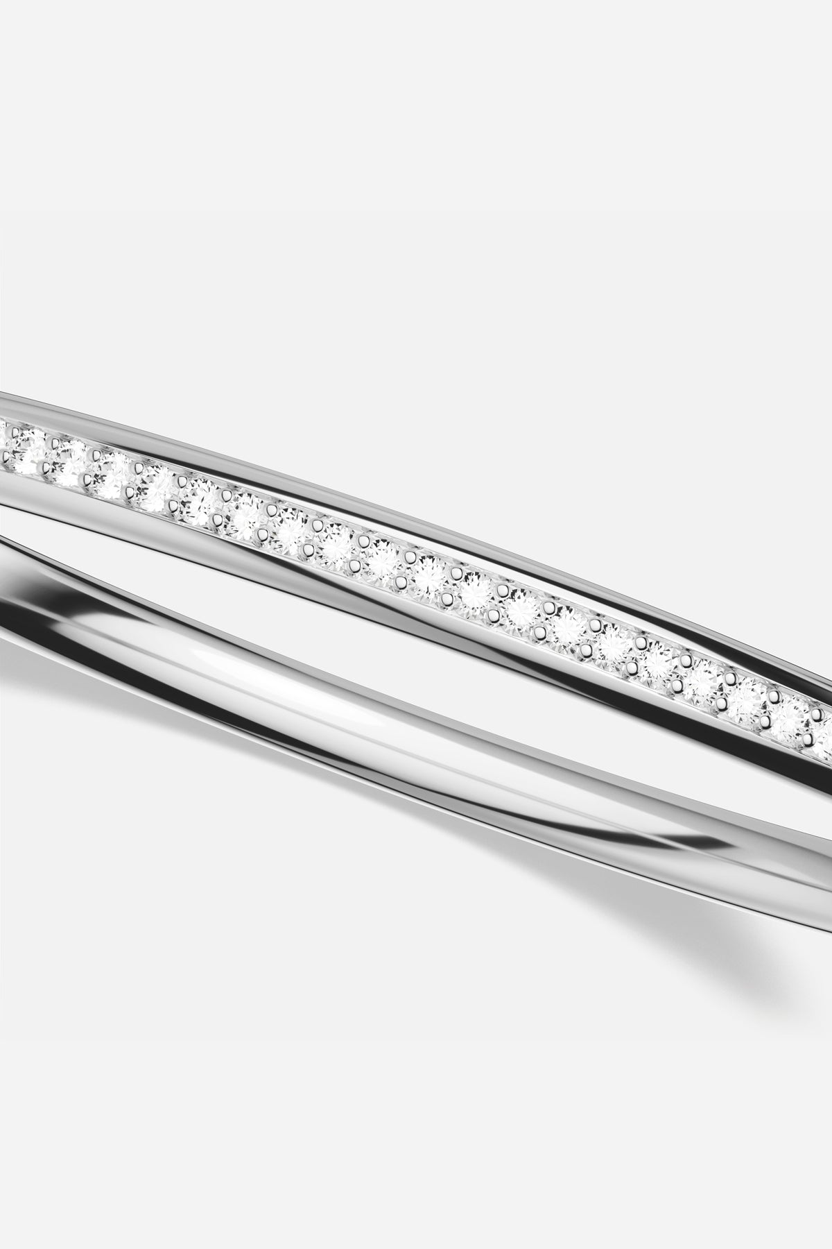 APM Bangle in rhodium finish, a sleek line of quiet radiance.