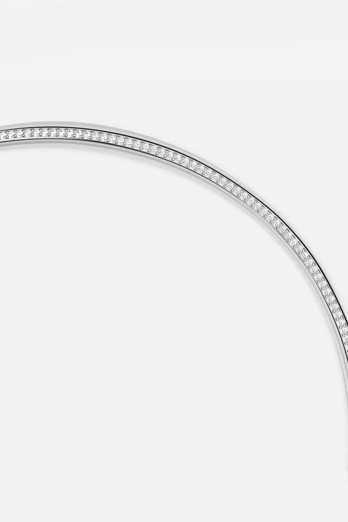 APM Bangle in rhodium finish, a sleek arc of quiet radiance.