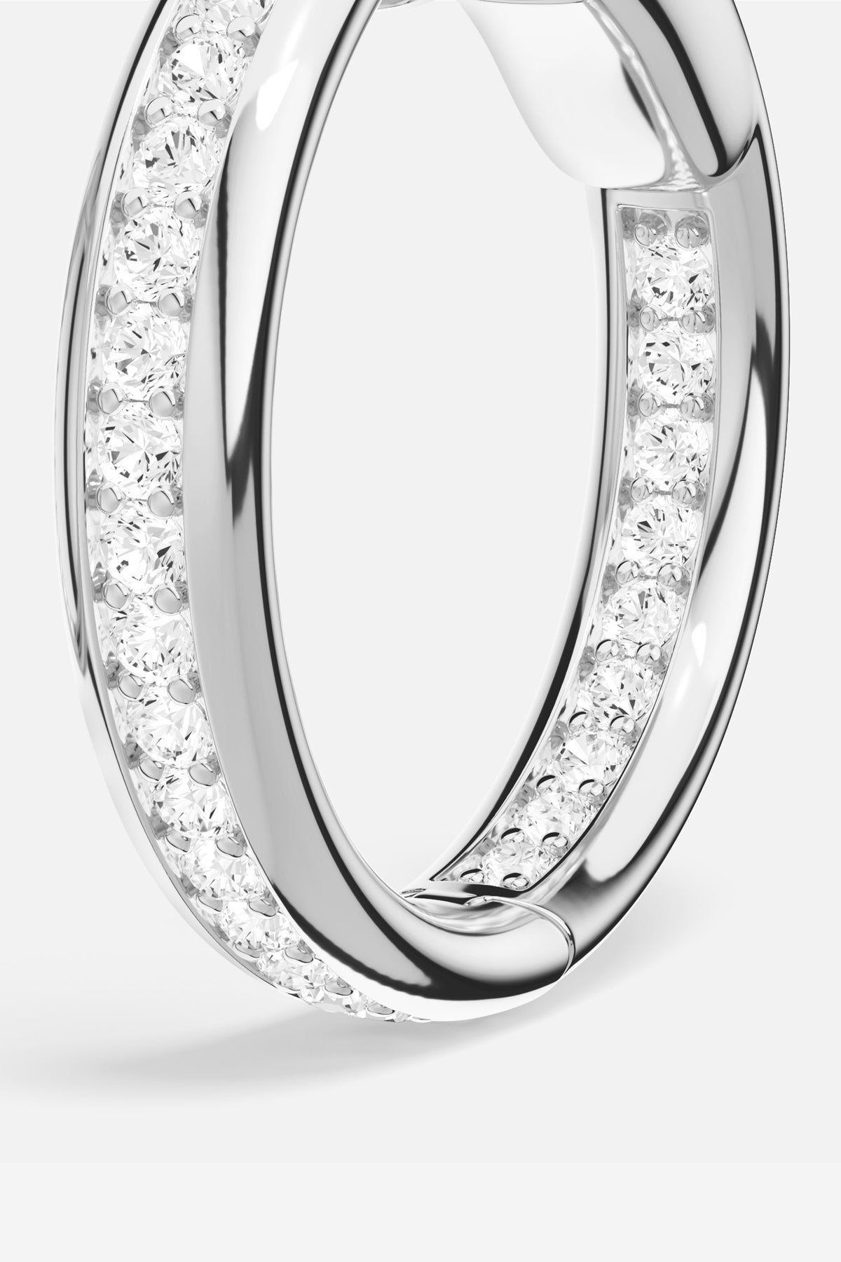 APM Hoop Earrings in rhodium finish, a luminous circle of quiet elegance.
