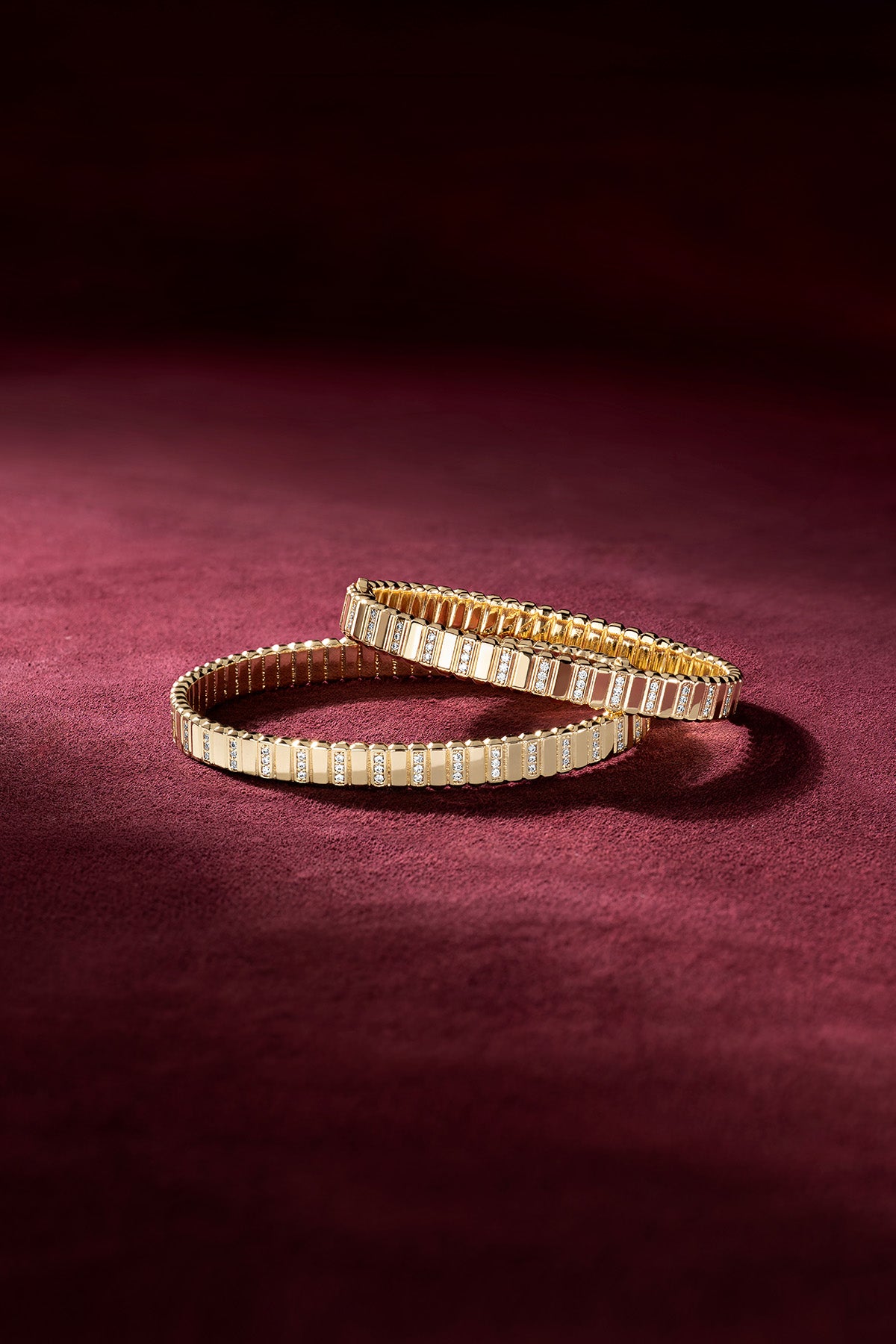APM Monaco bracelets in golden color, radiant elegance on velvet.