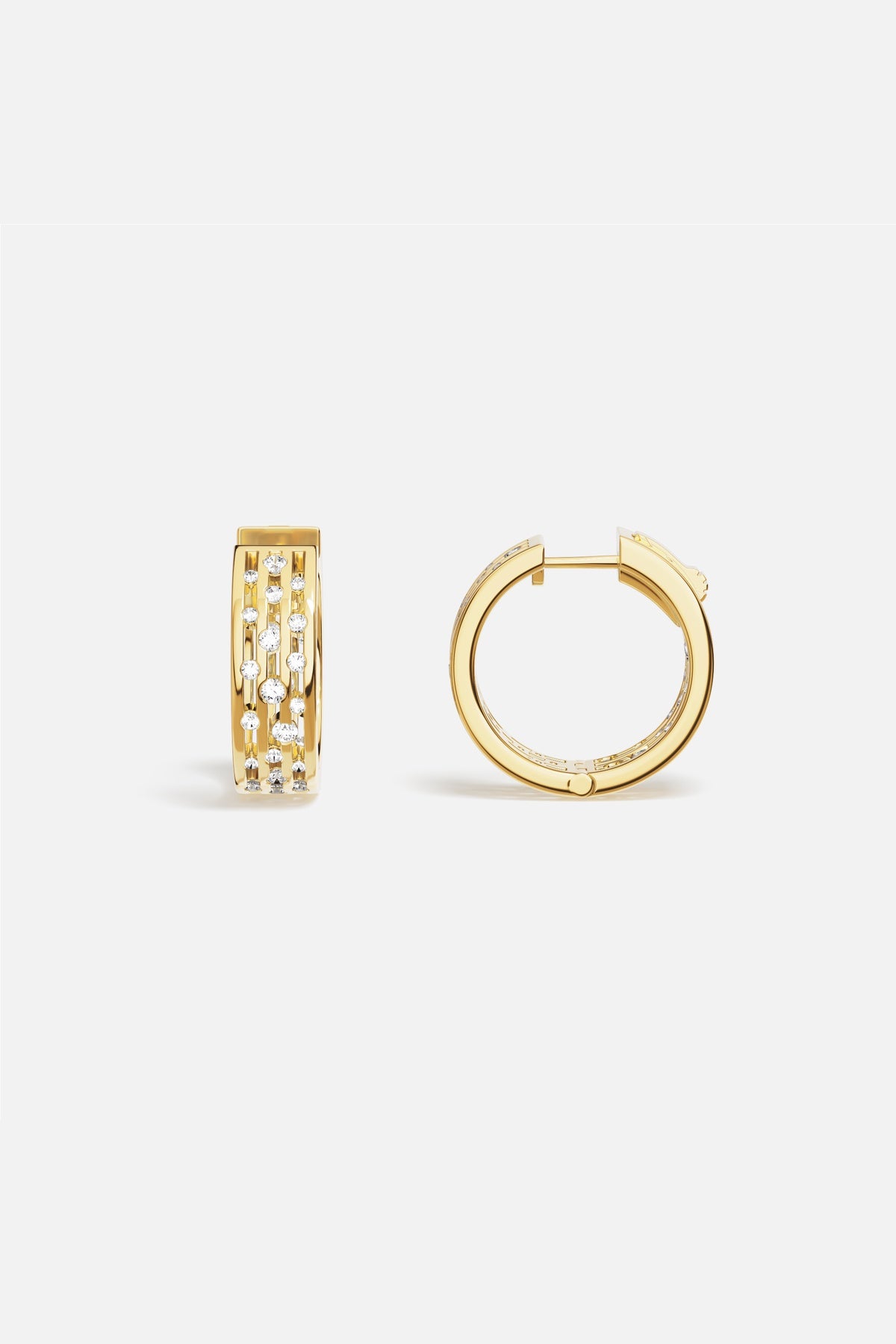 APM Monaco hoop earrings in golden color, a scattering of light, effortlessly radiant.