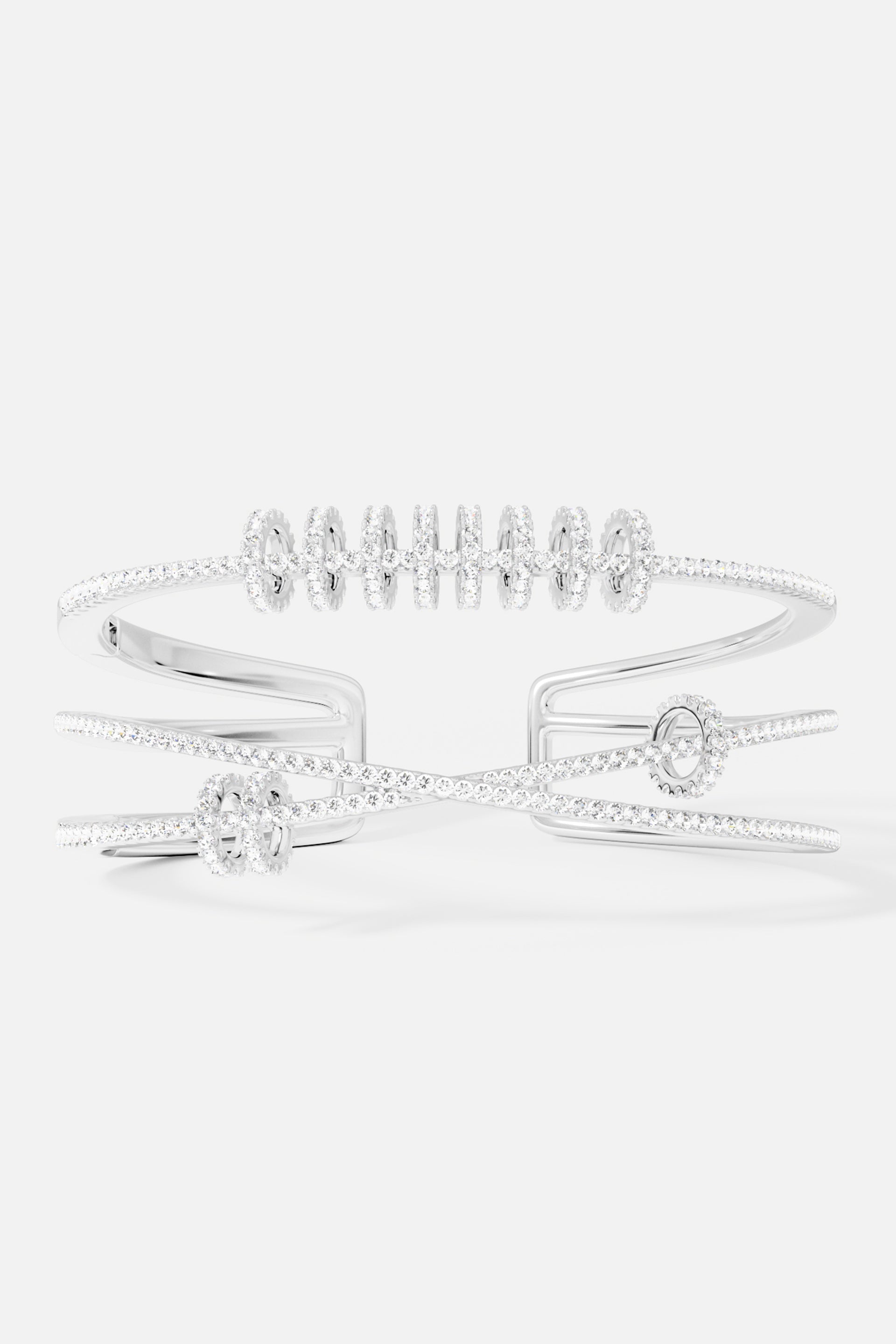 Bracelets APM Monaco: silver-tone triple cuff with sliding rings and pavé embellishments.