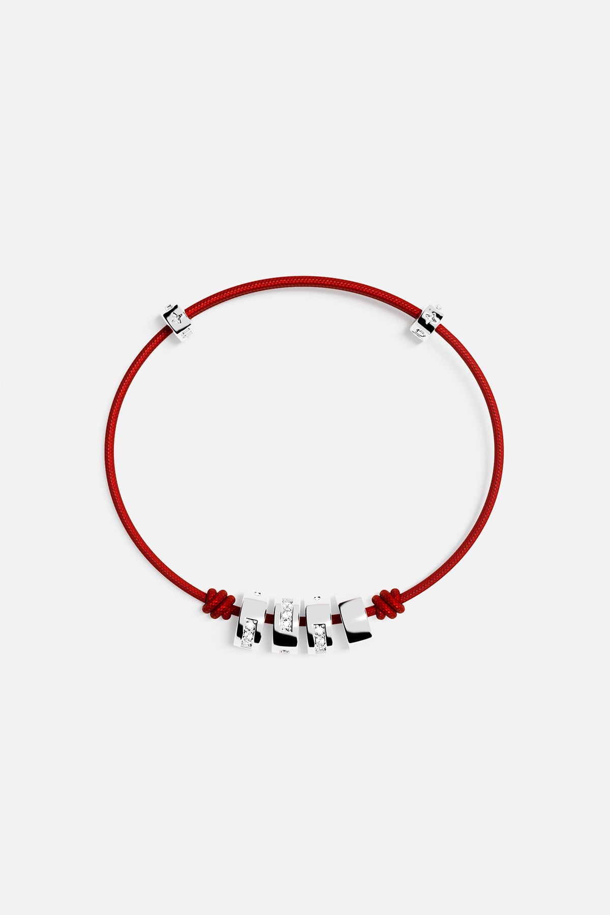 Bracelets APM Monaco morse-code string bracelet with red cord and four silver beads, three with pavé diamonds.