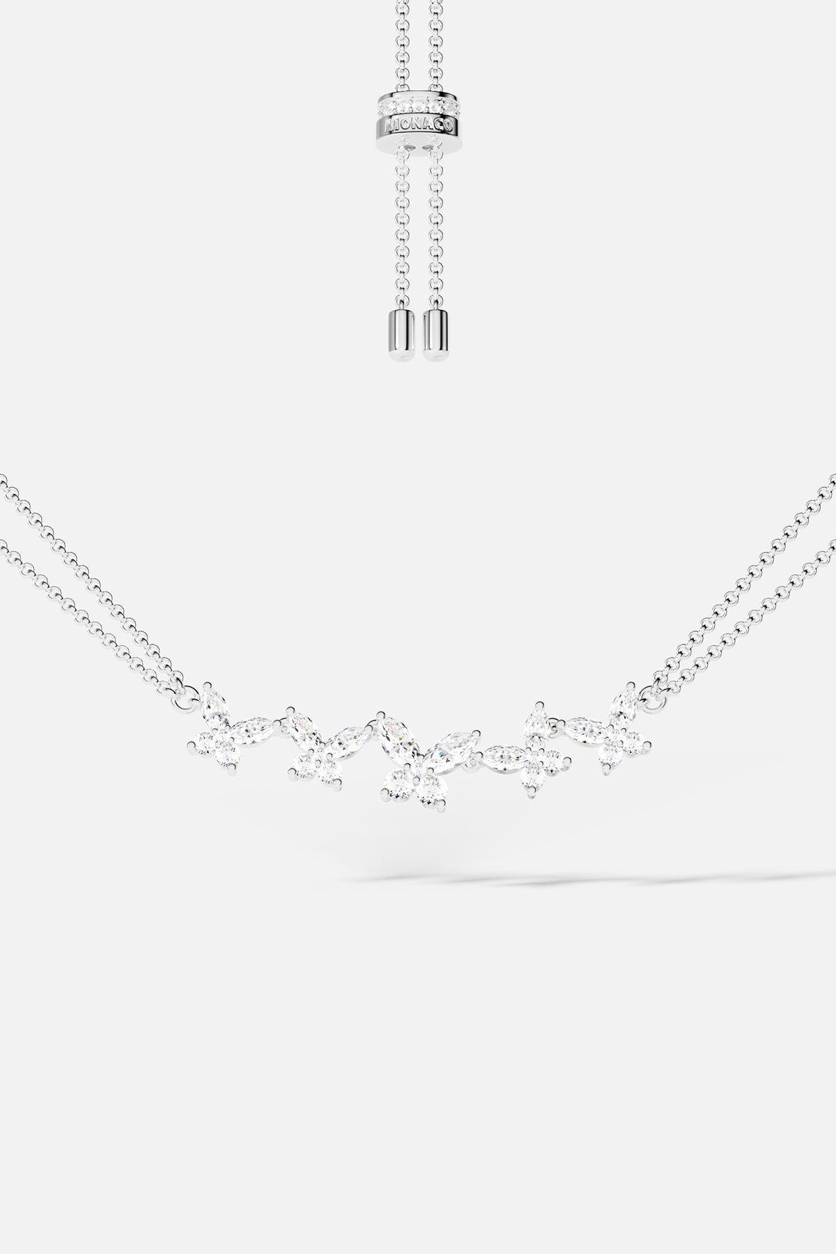 Necklaces APM Monaco: butterfly-pattern necklace with white crystals on a double-chain, adjustable length in silver-tone metal.