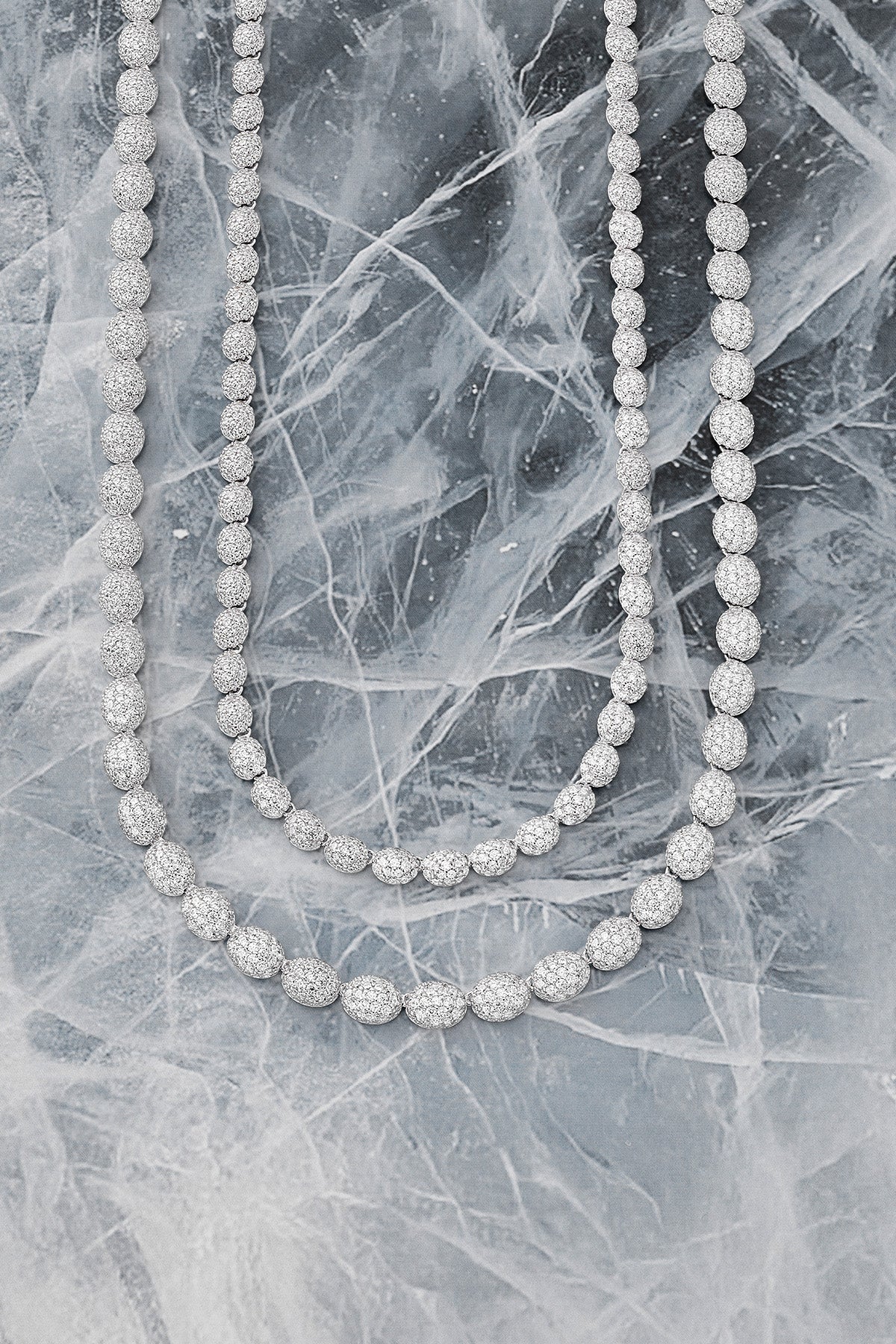 APM MONACO pave necklace in silver on iced background