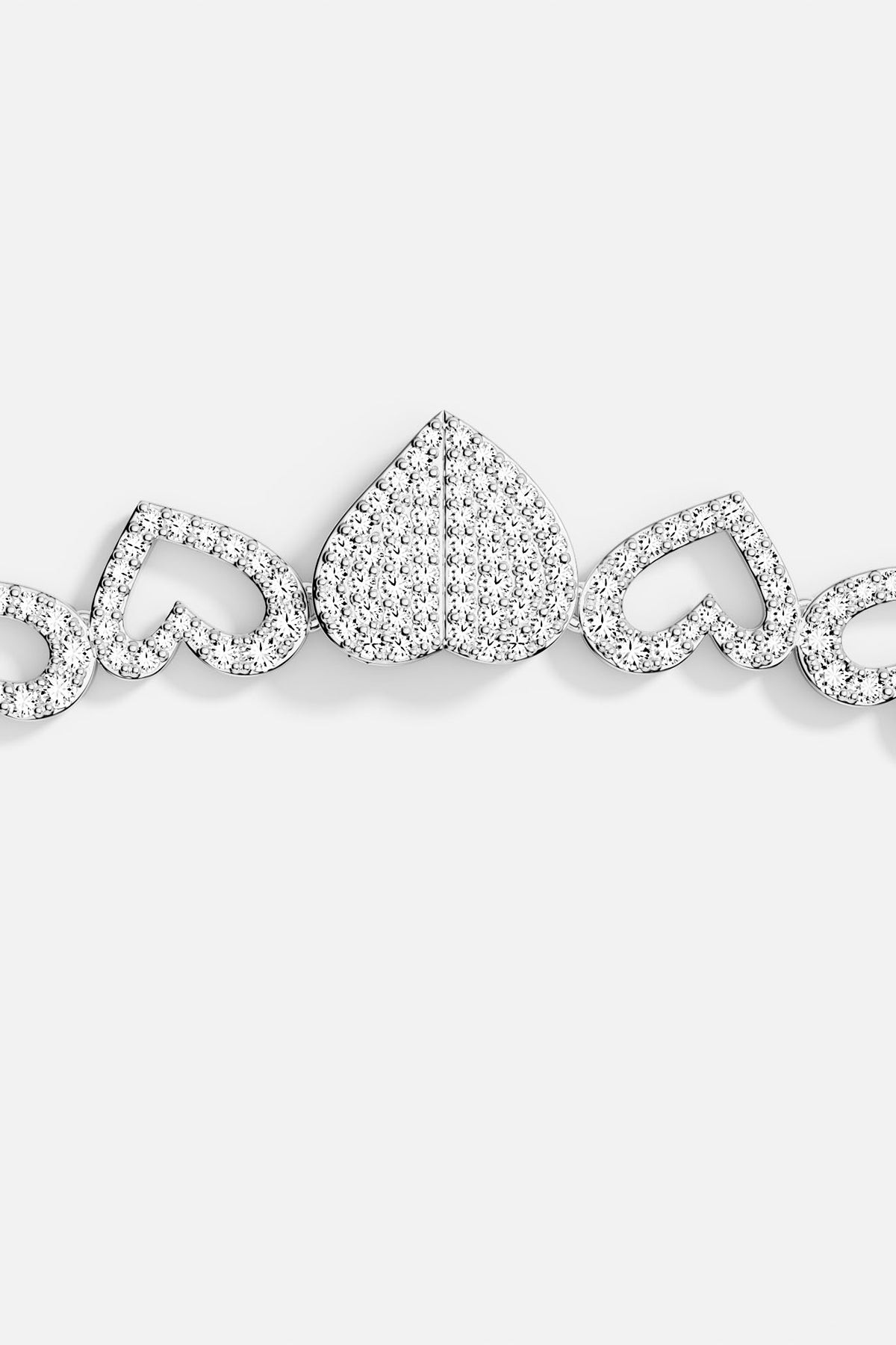 Close-up of silver bracelet with heart-shaped clasp on a white background