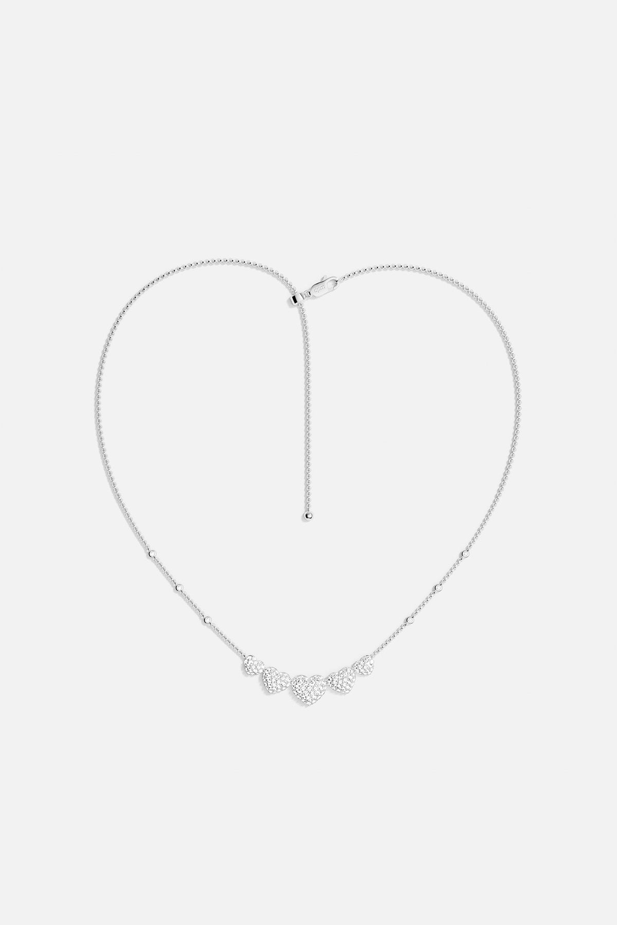 APM MONACO silver necklace with five heart-shaped pendants design on a white background