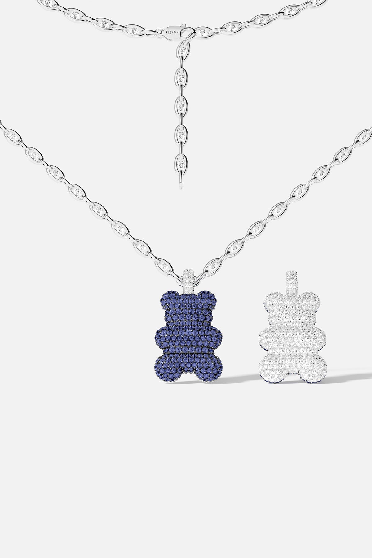 Blue teddy bear pavé pendant necklace with white teddy bear pavé pendant against a white background