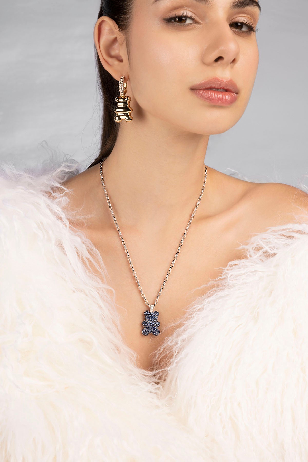 A model is wearing APM Monaco Master Baba Yummy Bear Adjustable Chain Necklace in Silver on neck 